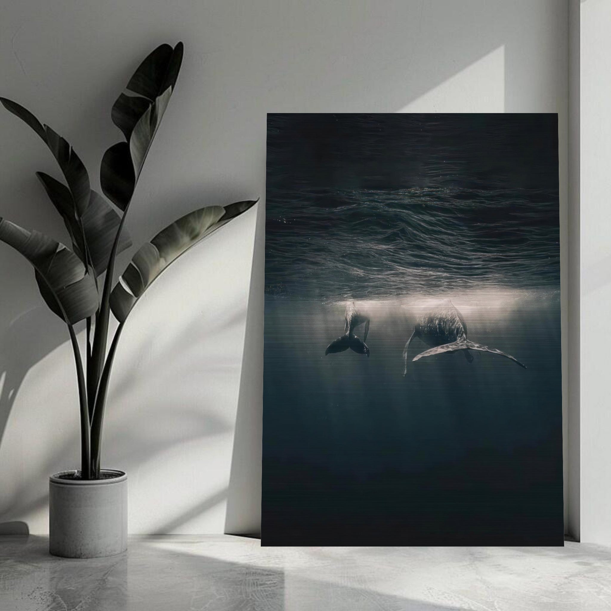 Whales gliding underwater in a brushed metal print, creating a serene ocean atmosphere in any space.