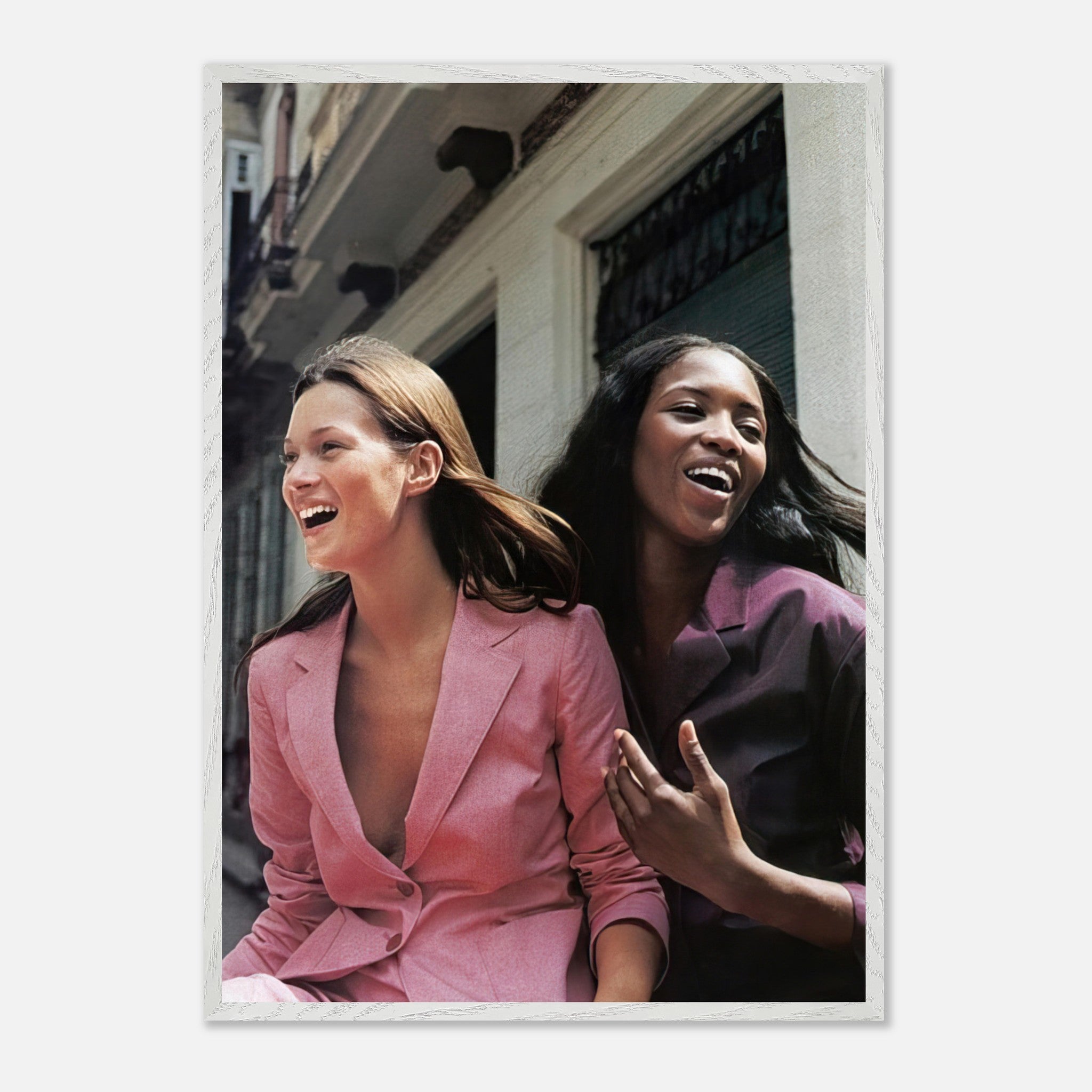 Naomi Campbell and Kate Moss laughing in vintage fashion, captured in an iconic framed print.