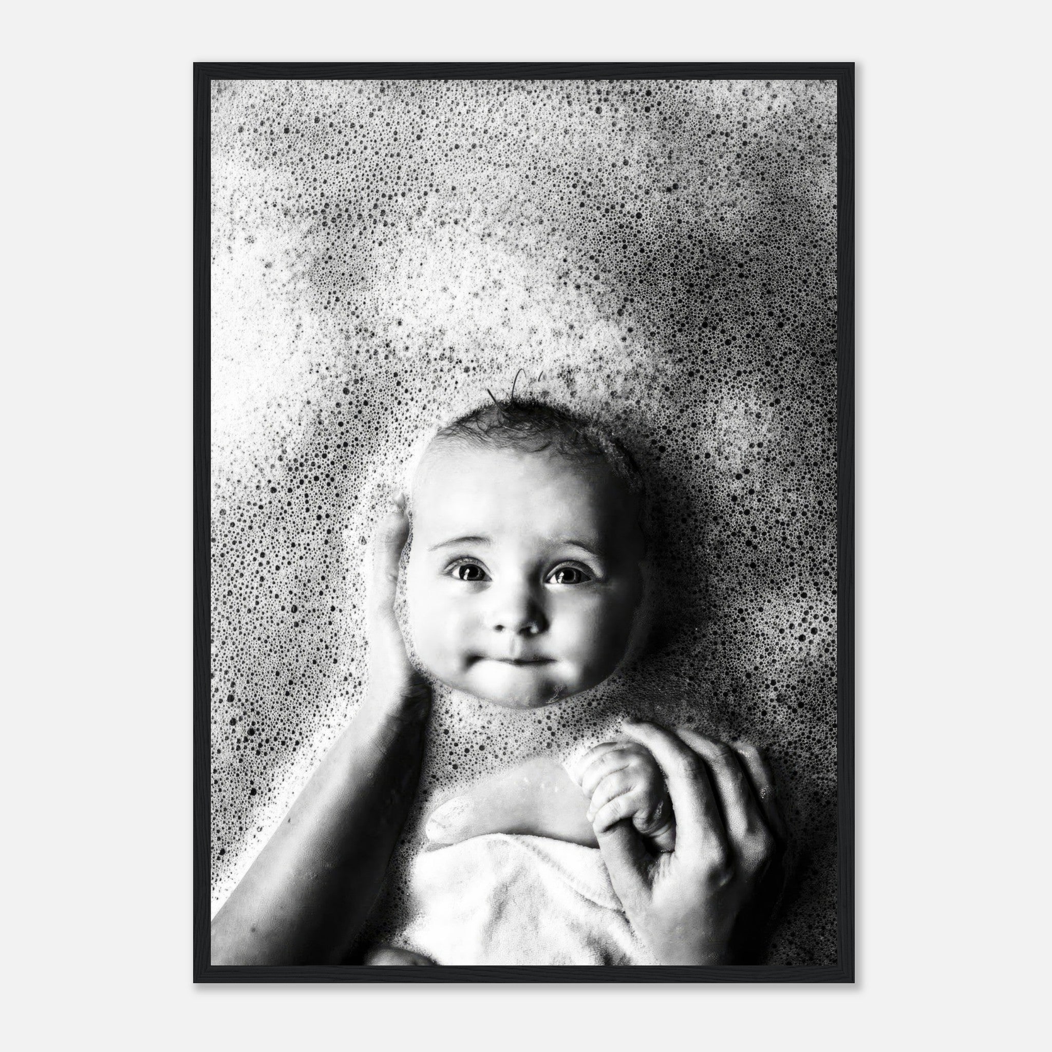 Black-and-white framed print of a smiling baby in a bubble bath, capturing innocence and joy in bath time.