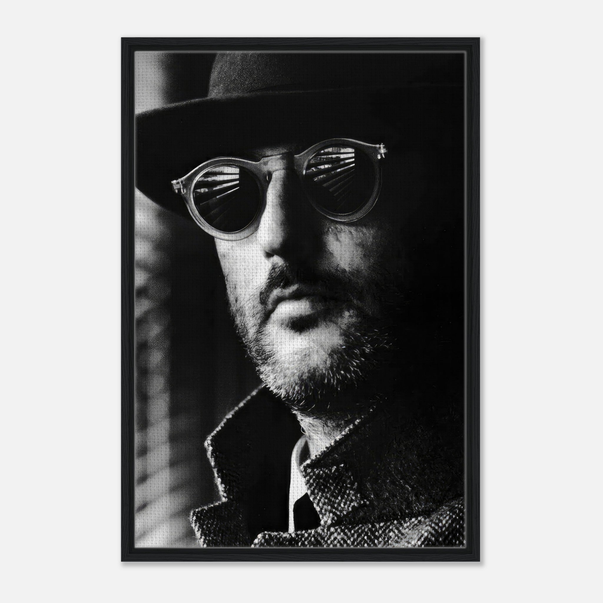 Framed black-and-white canvas print of Jean Reno in sunglasses with dramatic shadows.