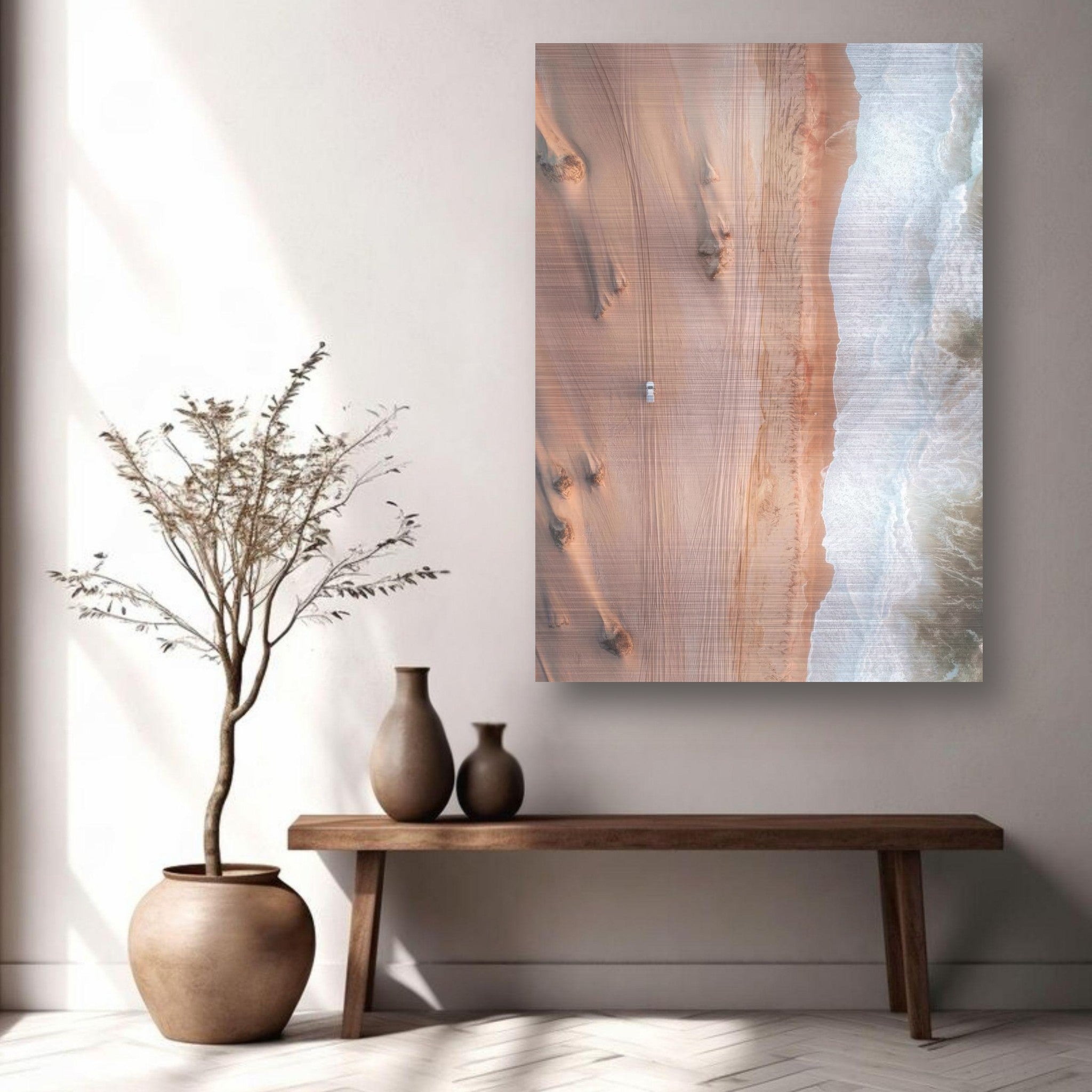 Drone photography of desert and ocean on brushed metal, showcasing warm sandy hues and cool waves.