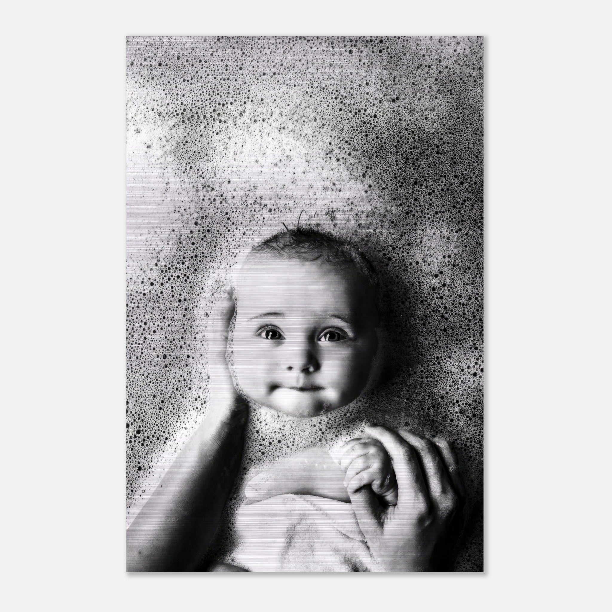 Black and white print of a baby with bubbles, capturing innocence in bath time on brushed metal.