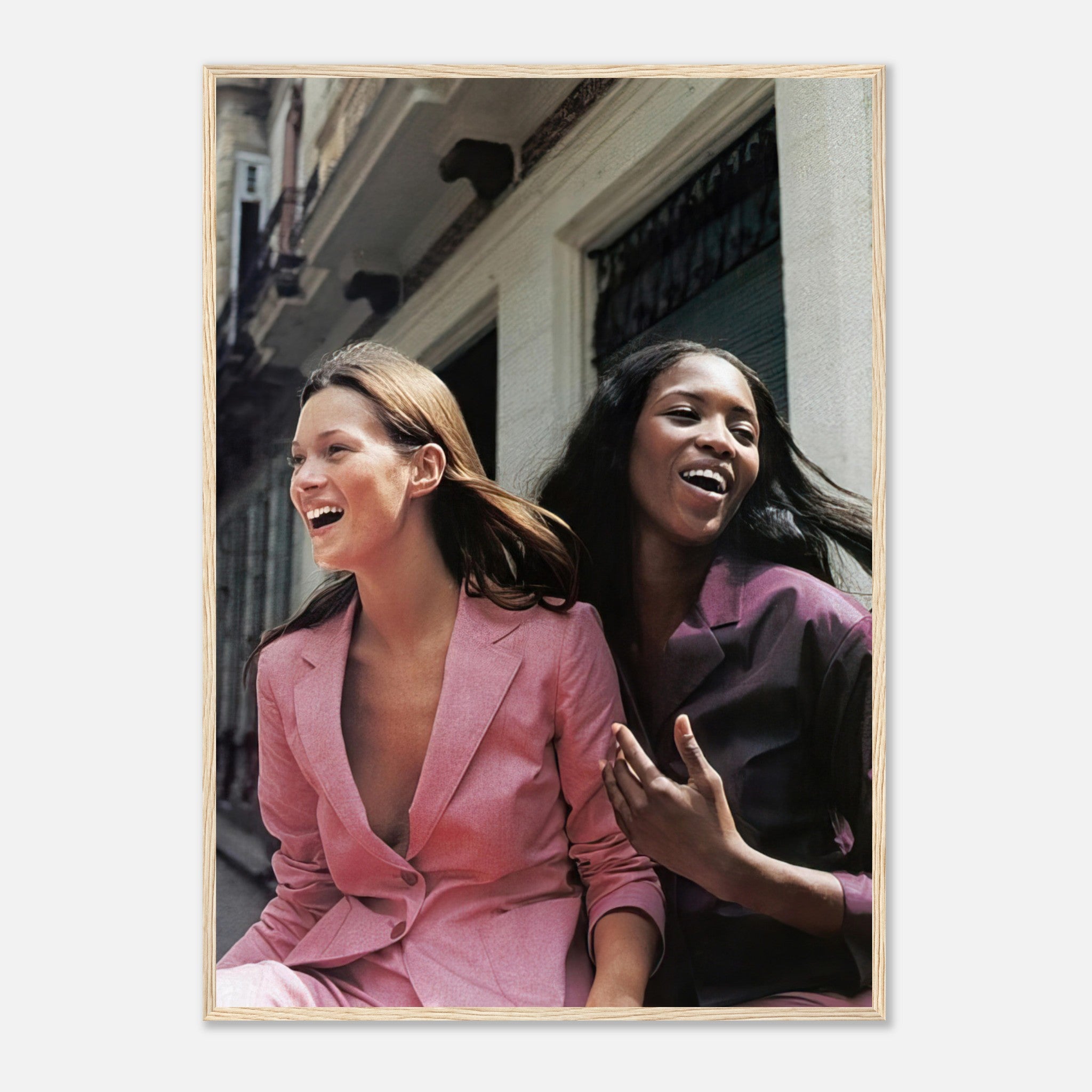 Framed print of Naomi Campbell and Kate Moss laughing, showcasing iconic fashion moments and elegance.