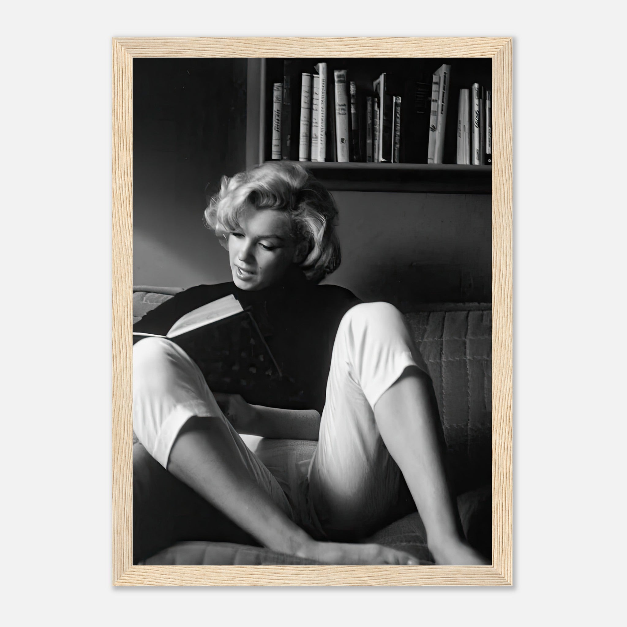 Marilyn Monroe reading at home, framed black-and-white print showcasing beauty and elegance.