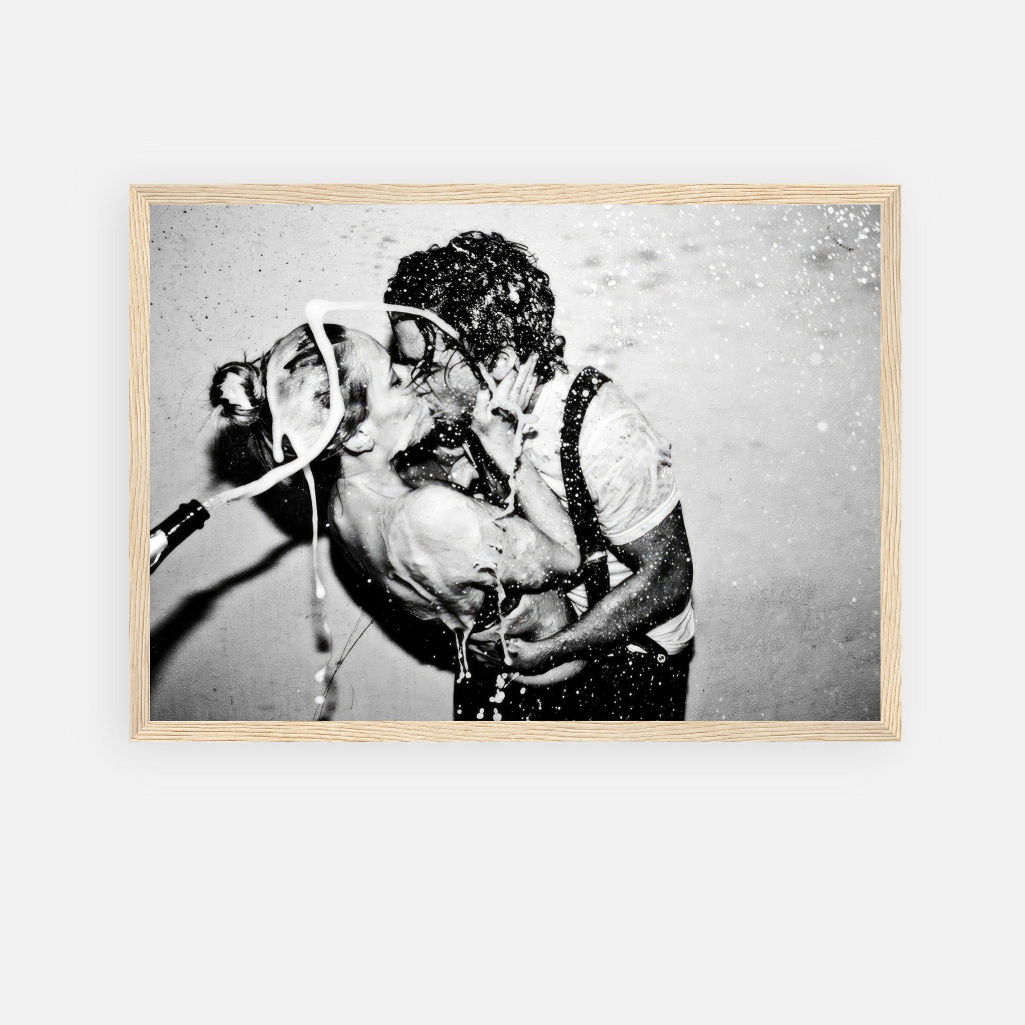 The Champagne Kiss framed print of Johnny Depp and Kate Moss in a passionate embrace with champagne explosion.