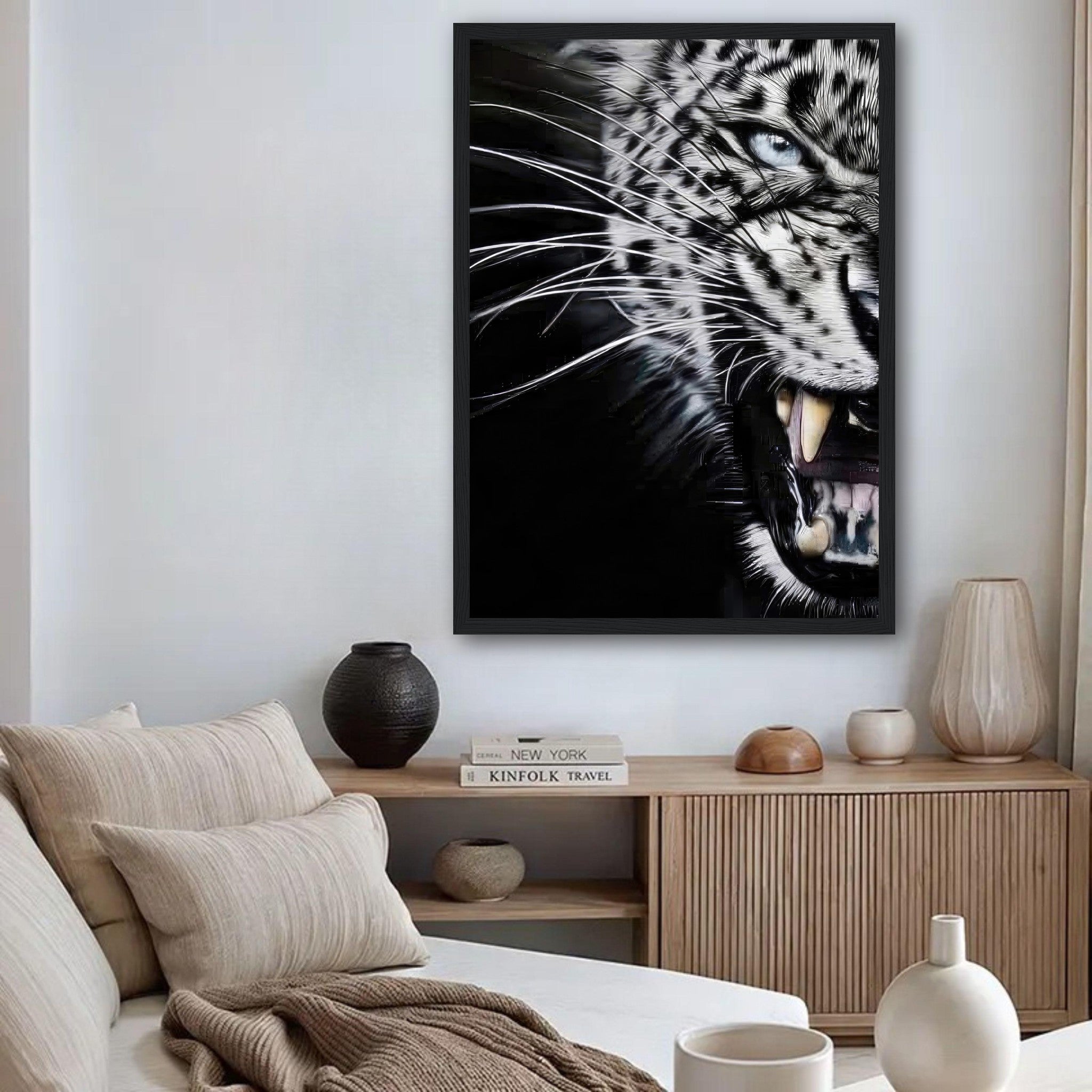 Close-up portrait of a fierce leopard in mid-snarl, showcased in a framed print adorning a stylish living room.