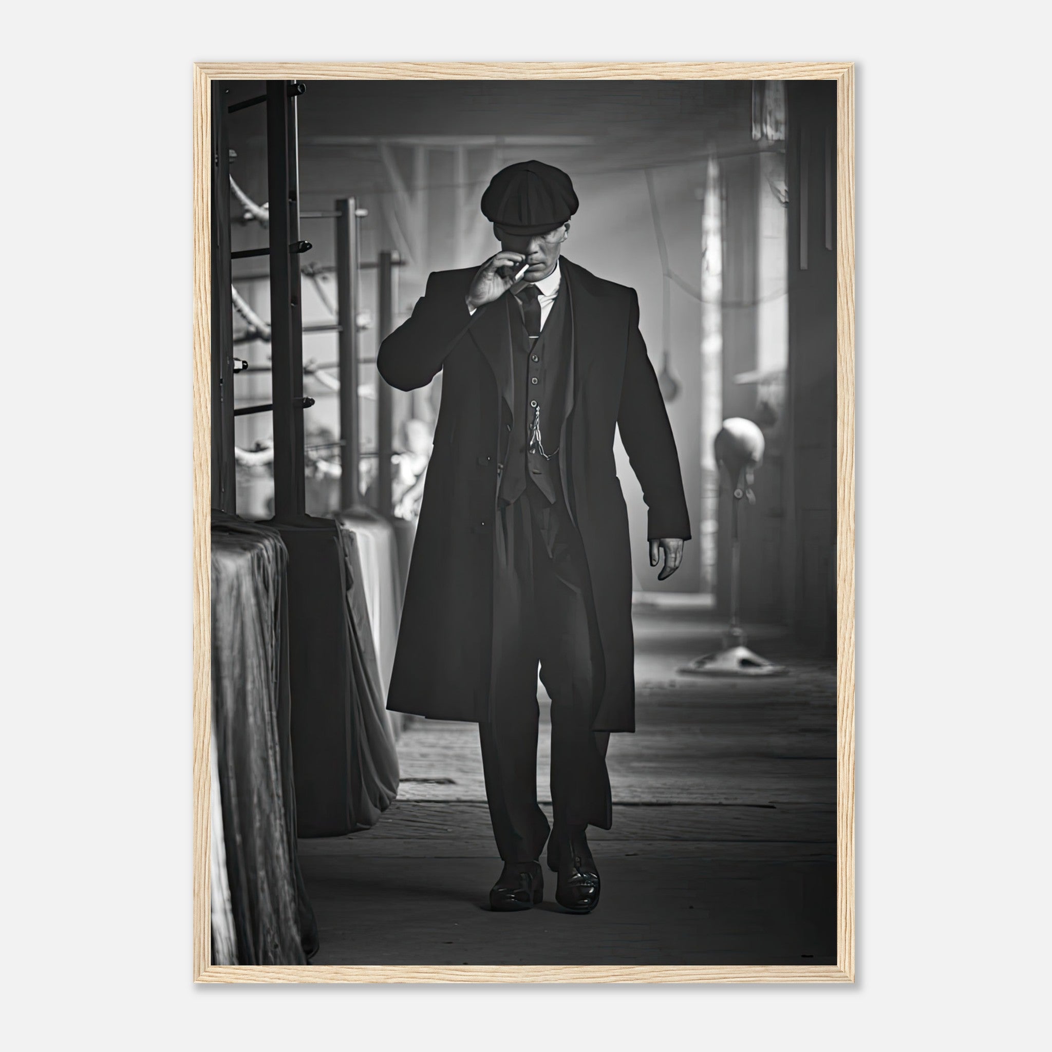 Tommy Shelby from Peaky Blinders framed print, showcasing 1920s style with flat cap and tailored overcoat.
