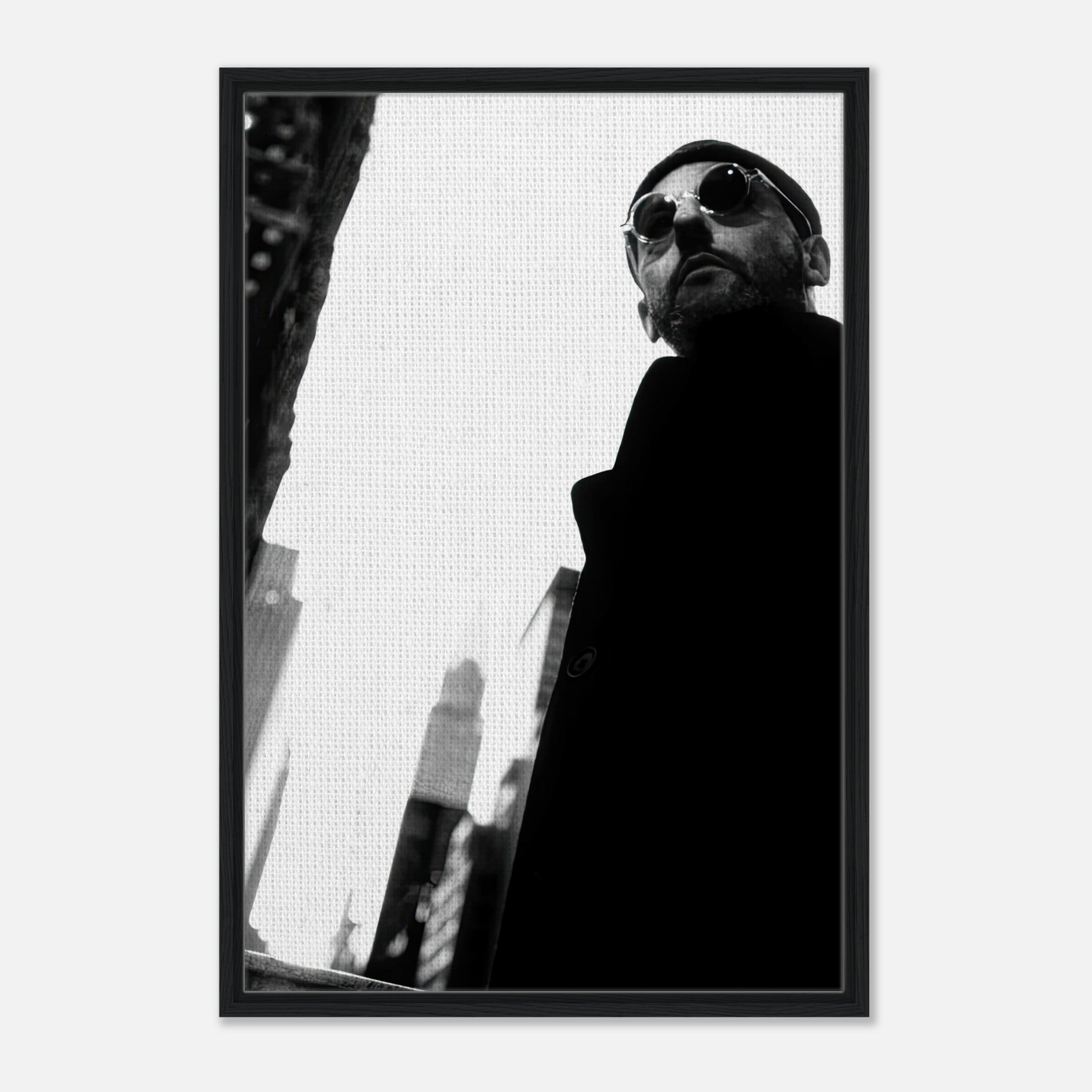 Jean Reno framed canvas print in black-and-white, showcasing urban sophistication and enigmatic charm.