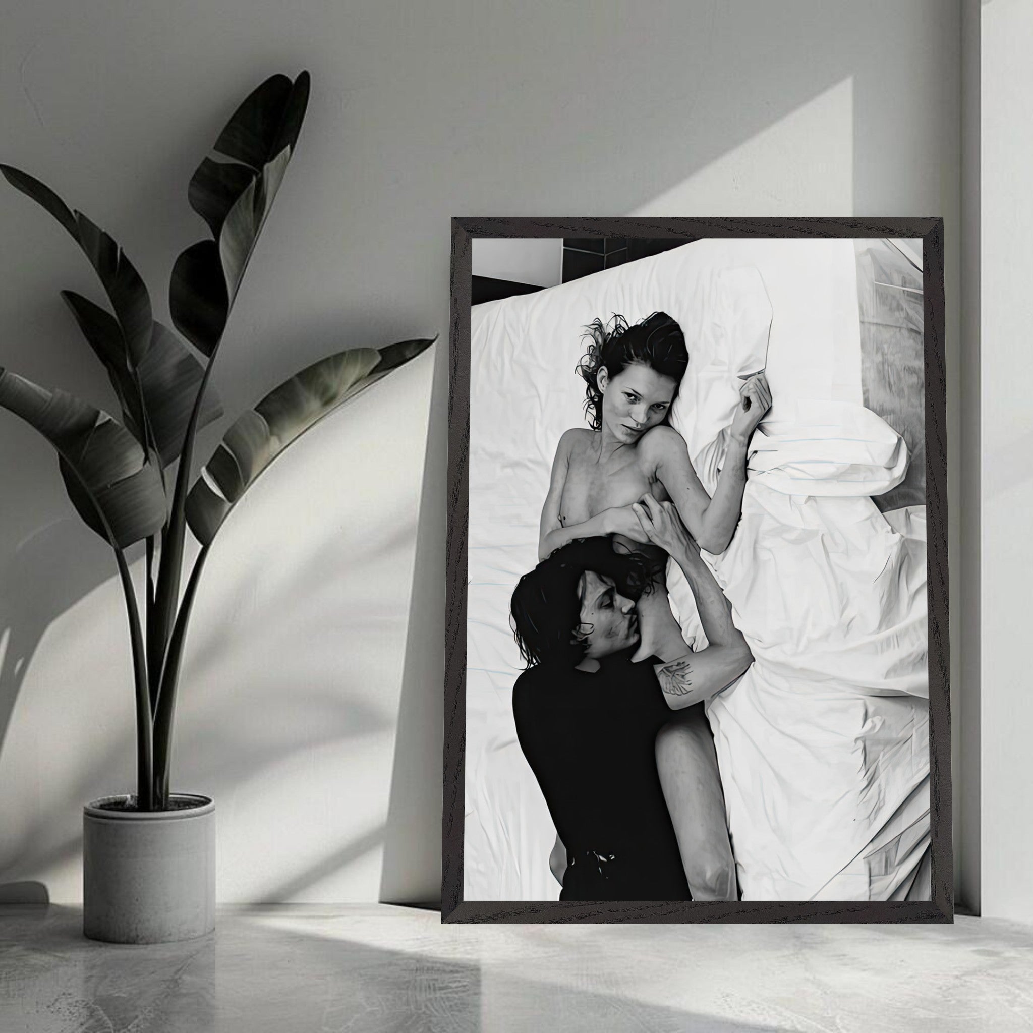 Black and white fine art print of a couple in an intimate pose on a bed, showcasing their chemistry and connection.
