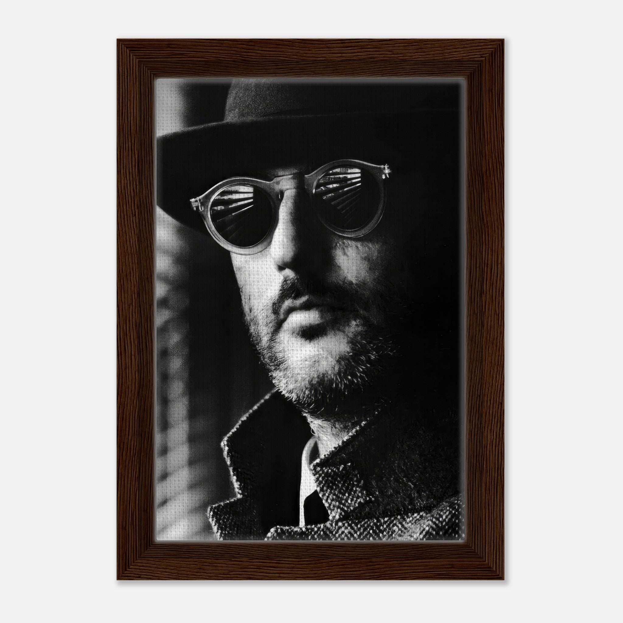 Jean Reno Leon framed canvas print featuring a striking black-and-white portrait with sunglasses and a hat.