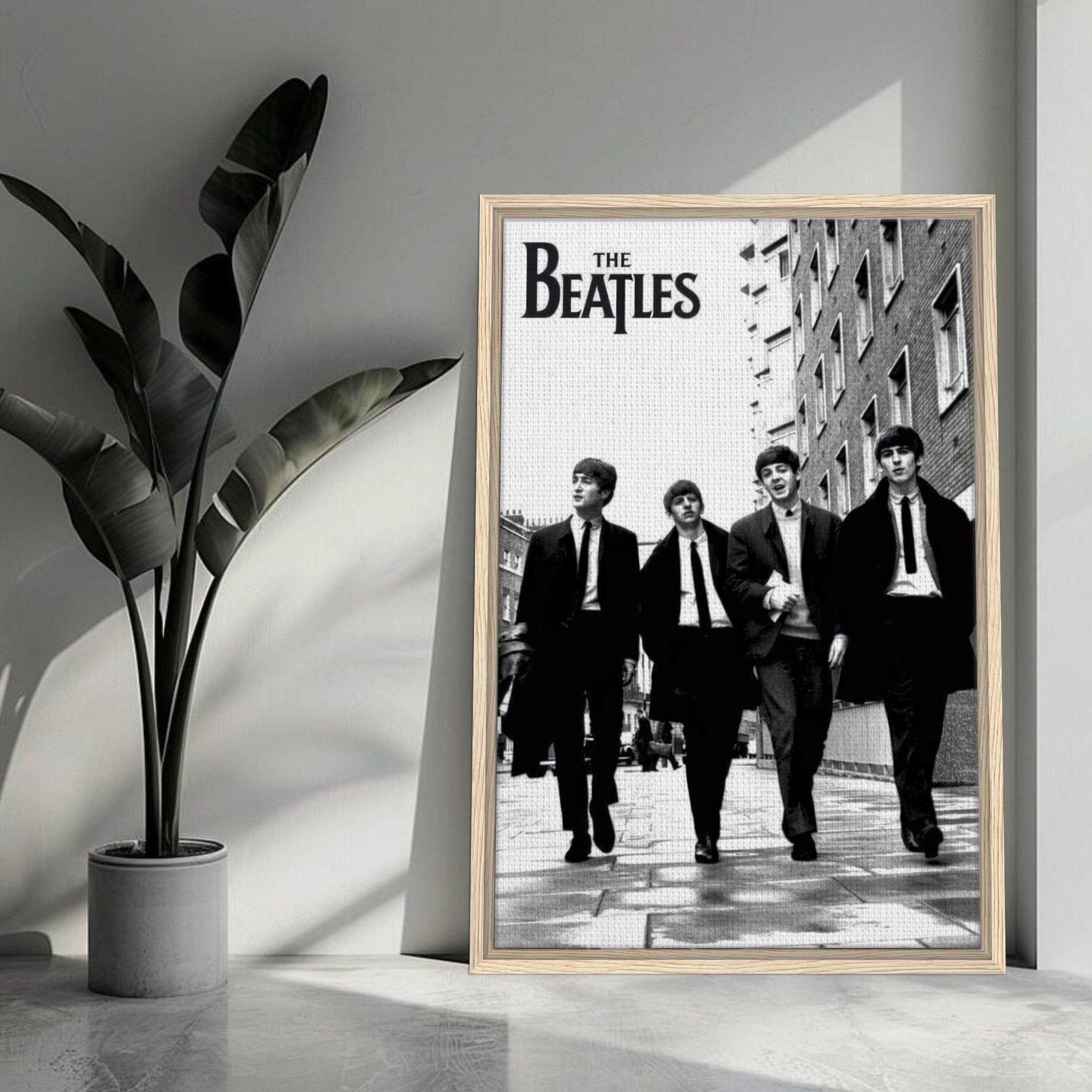 The Beatles framed canvas print featuring iconic band members walking in black and white, perfect for music lovers' decor.