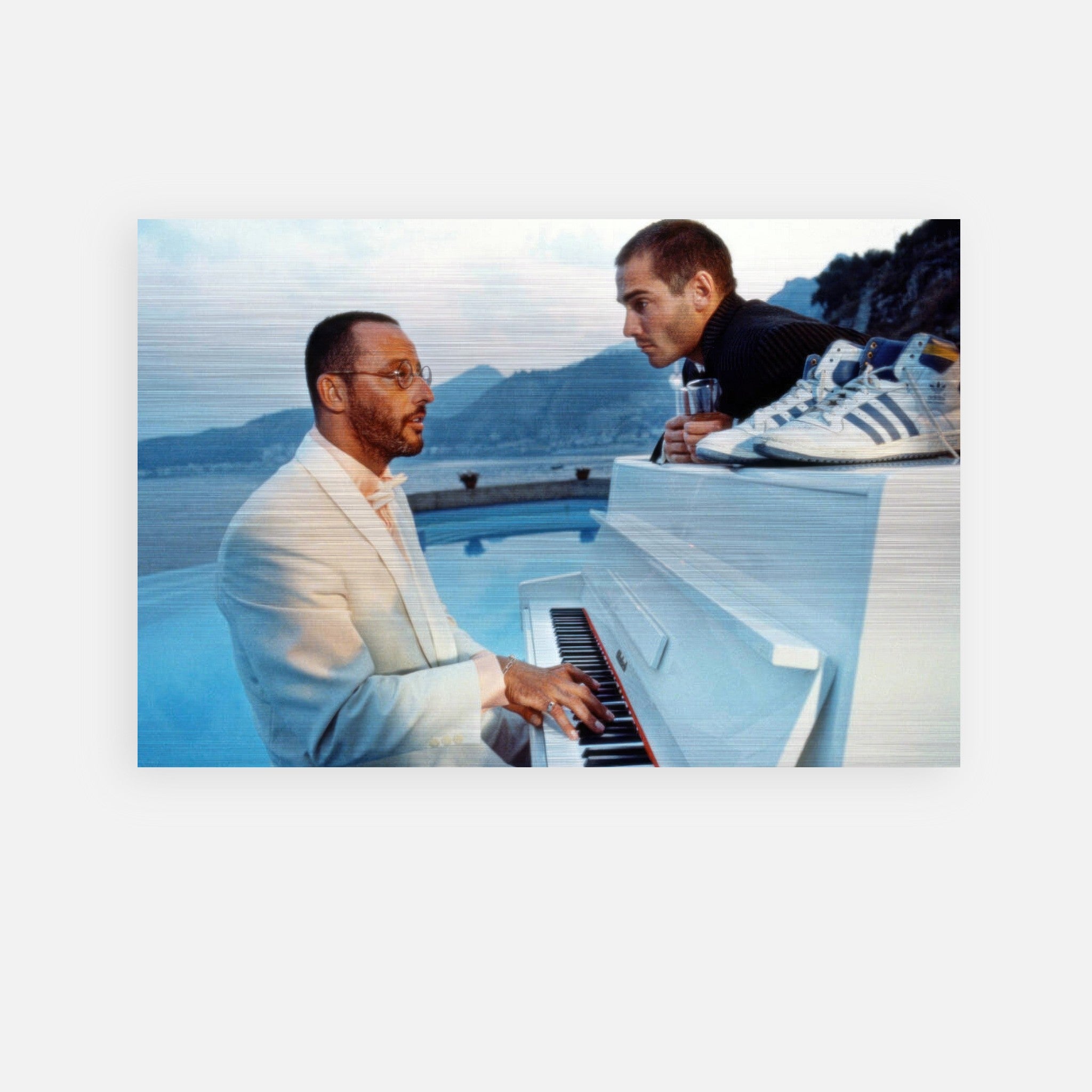 two men interacting at a white piano near a scenic ocean view, showcasing elegance and musical passion.