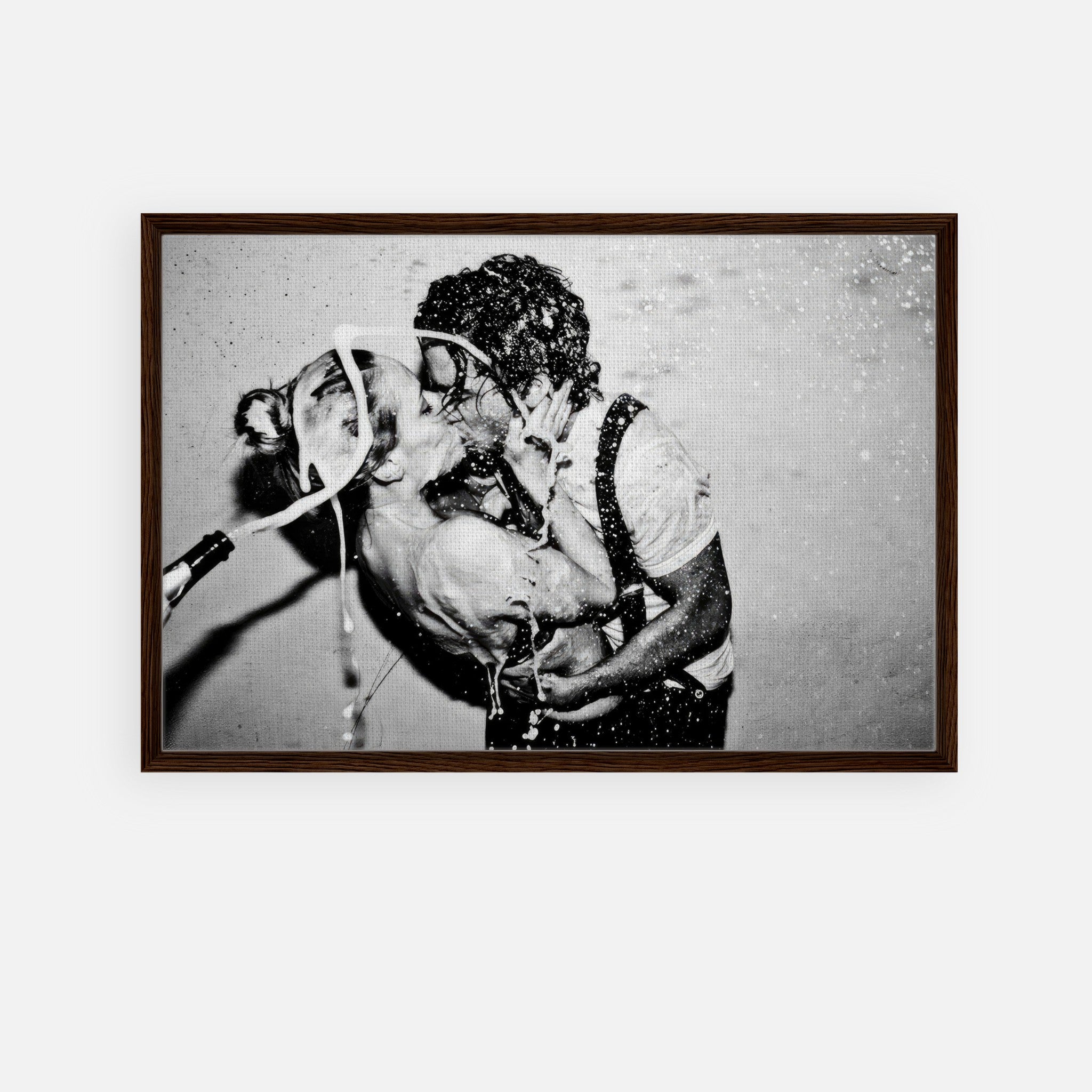 Black-and-white framed print of Johnny Depp and Kate Moss sharing a kiss in a champagne explosion.