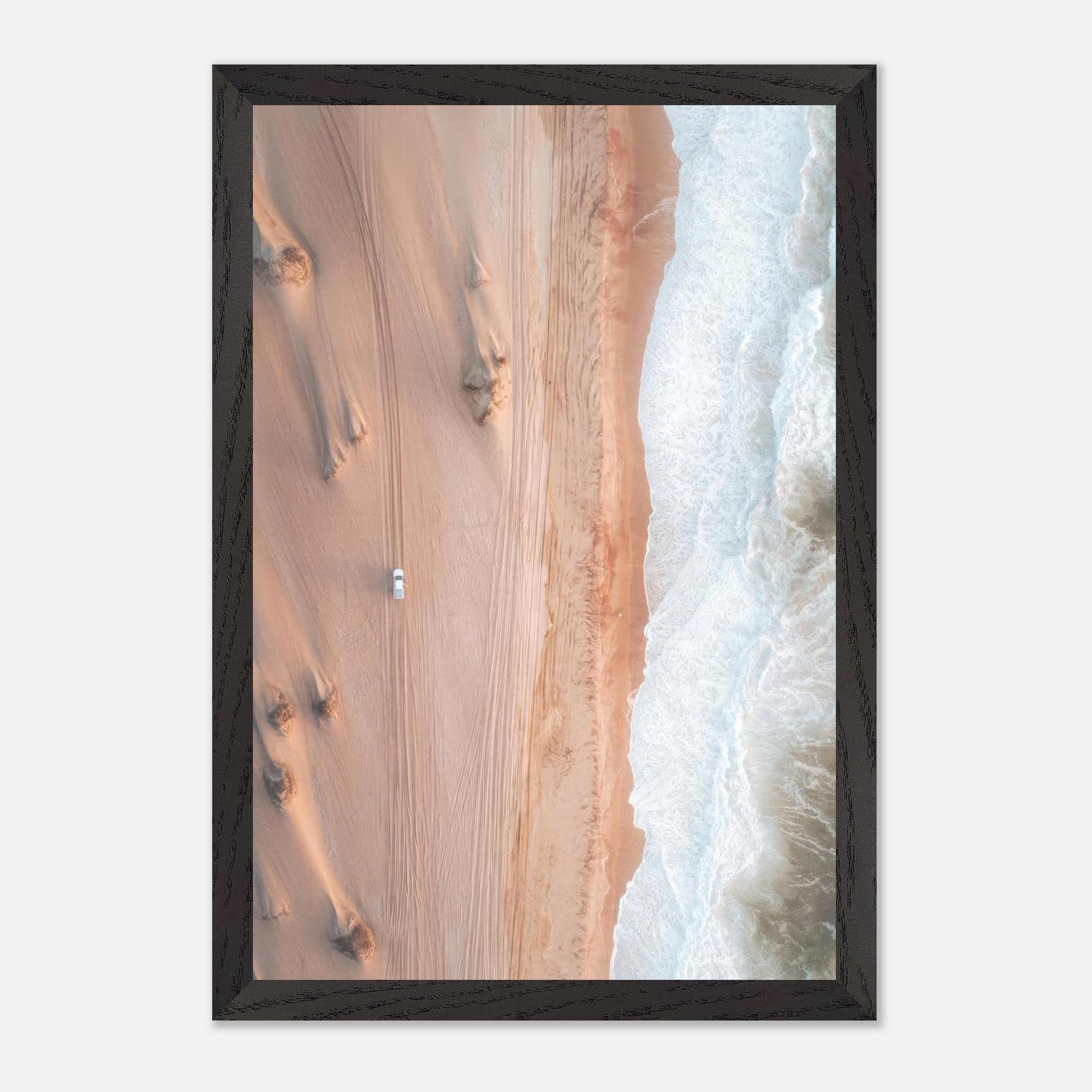 Aerial view of golden desert dunes meeting the turquoise ocean in a fine art drone photograph.