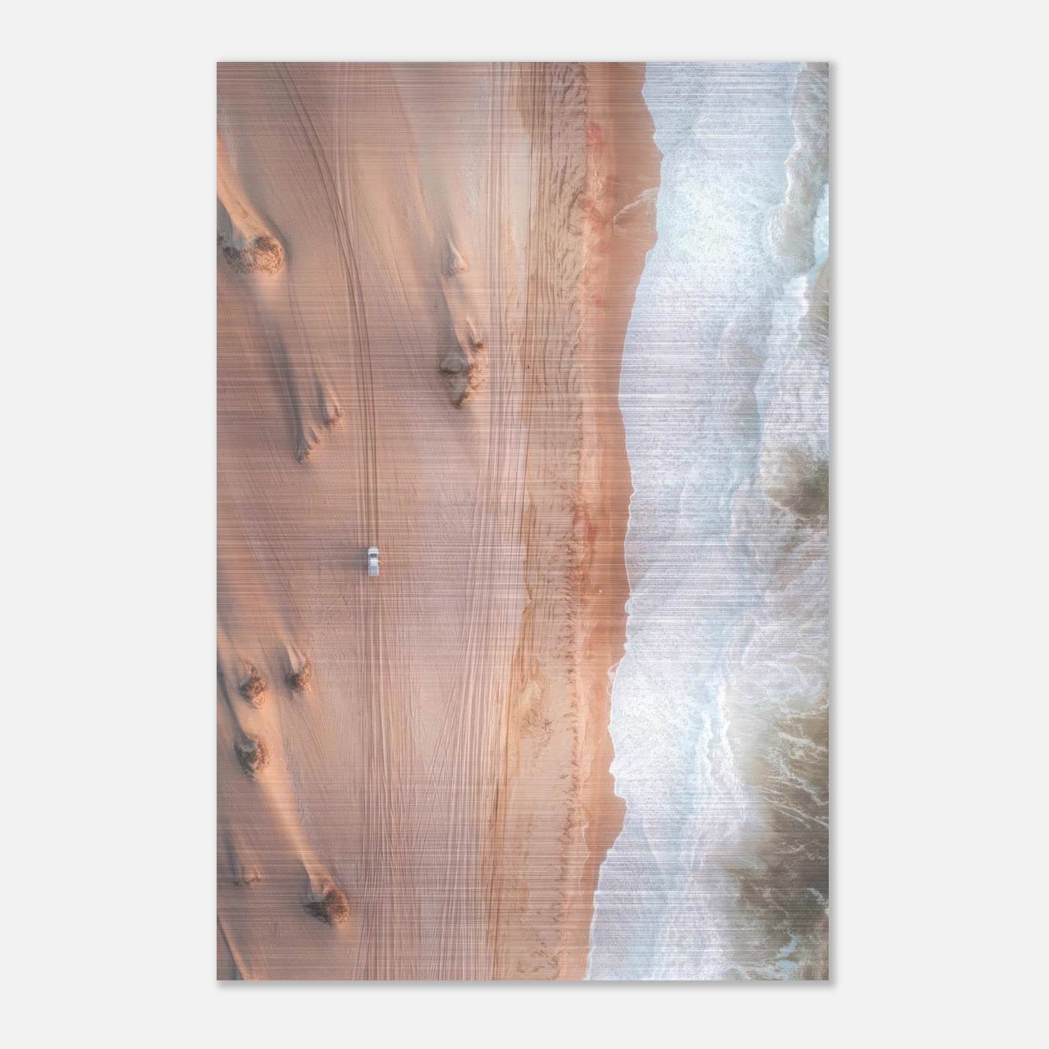 Aerial drone photograph of desert dunes meeting ocean waves, captured on brushed metal print.