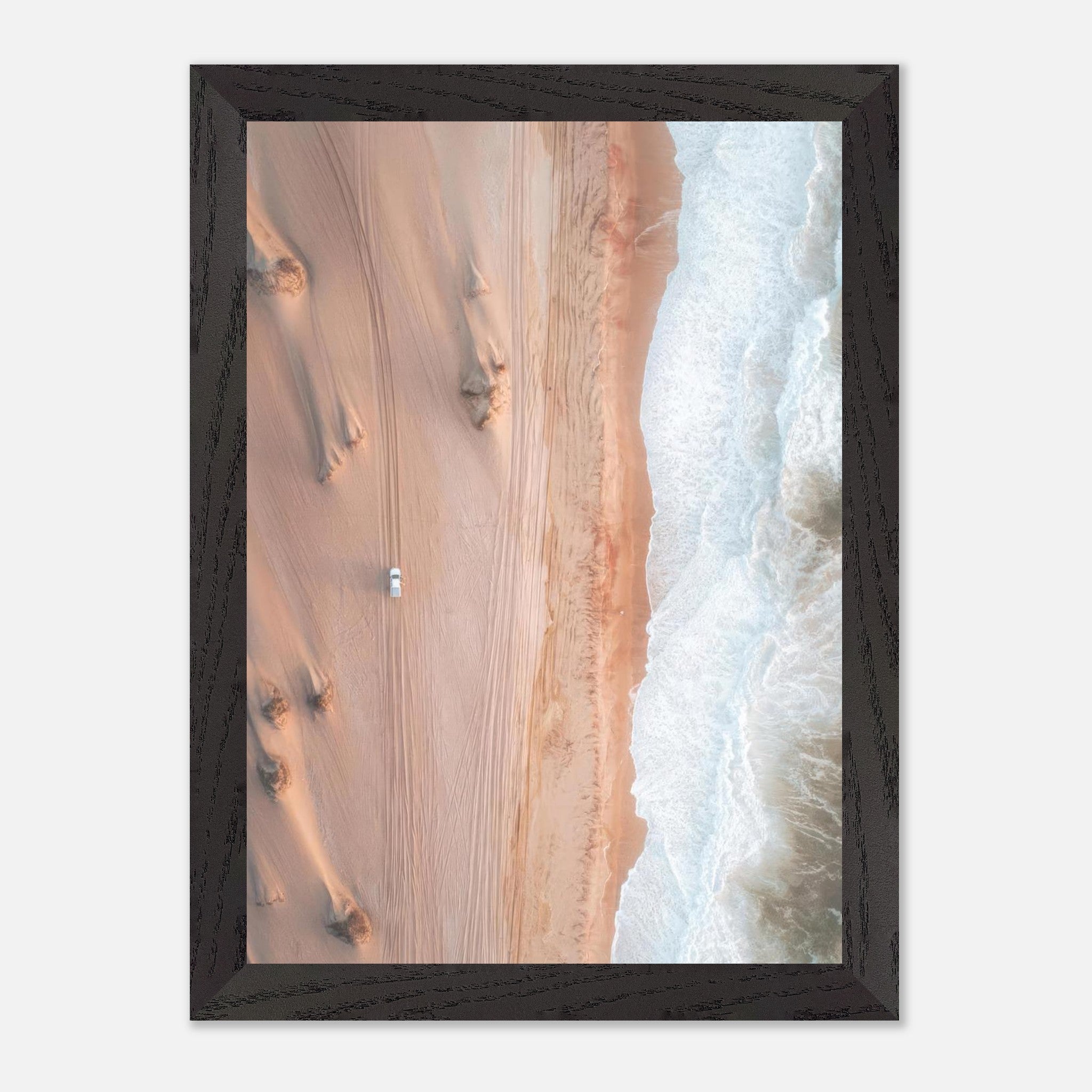 Drone photography of desert and ocean contrast with a vehicle on sandy dunes, framed print for home decor.