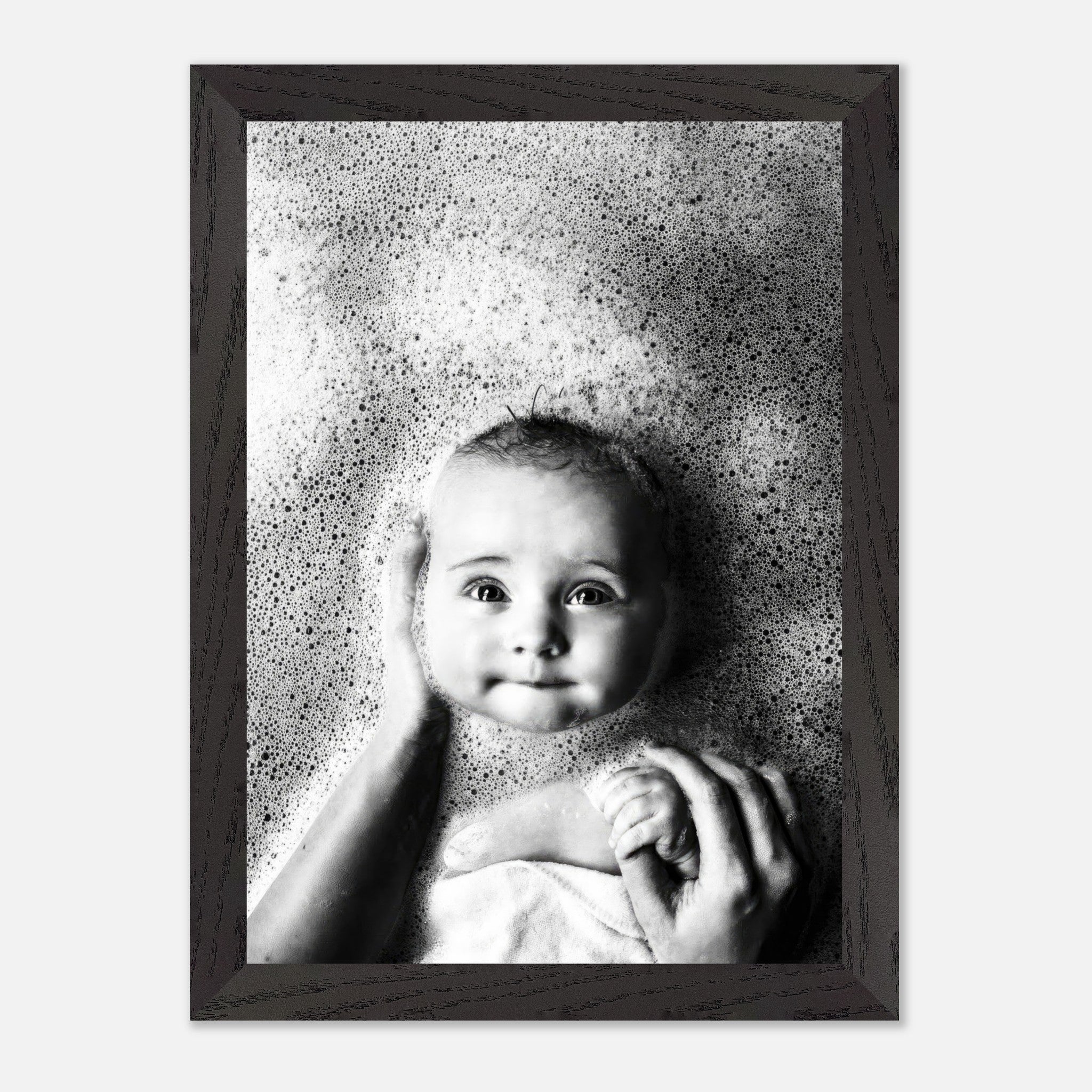 Serene baby in bubbles captured in vintage black and white framed print, evoking nostalgic innocence.
