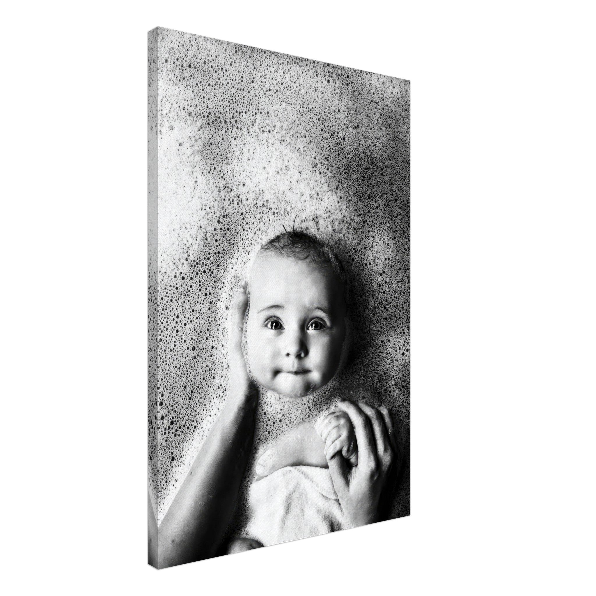 Black-and-white canvas print of a baby in a bath surrounded by bubbles, capturing innocence and joy.