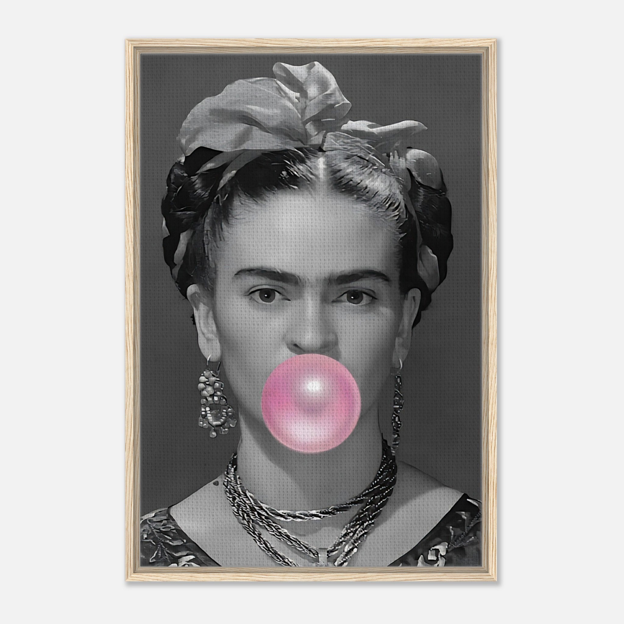 Frida Kahlo framed canvas print with grayscale portrait and pink bubble gum bubble, set in natural Wood frame.