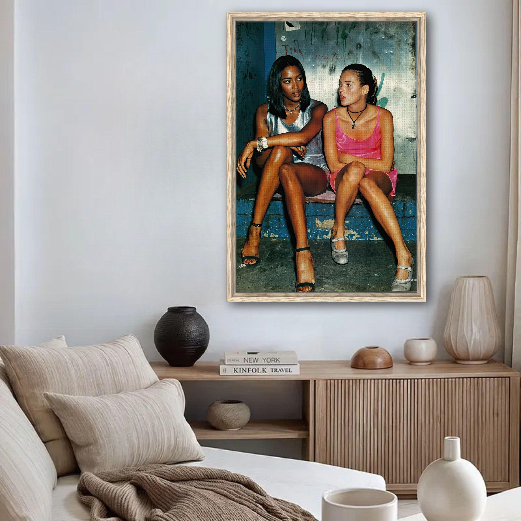 Framed canvas print of Naomi Campbell and Kate Moss embodying 90s supermodel glam in a stylish living room setting.
