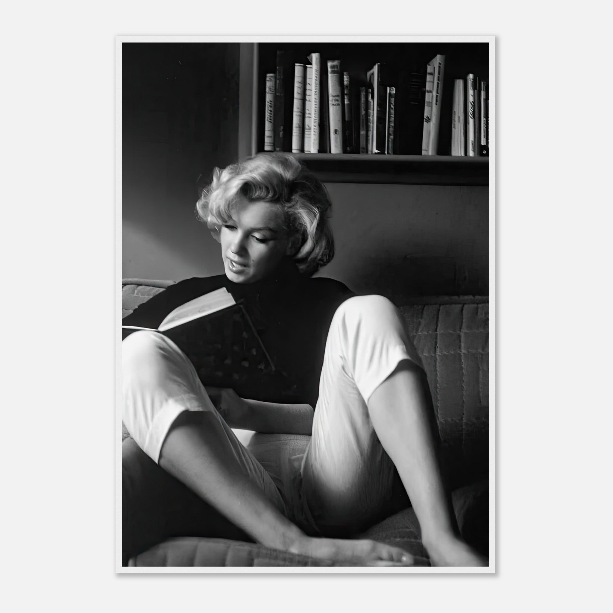 Marilyn Monroe reading at home, elegant black-and-white framed print showcasing classic Hollywood charm.