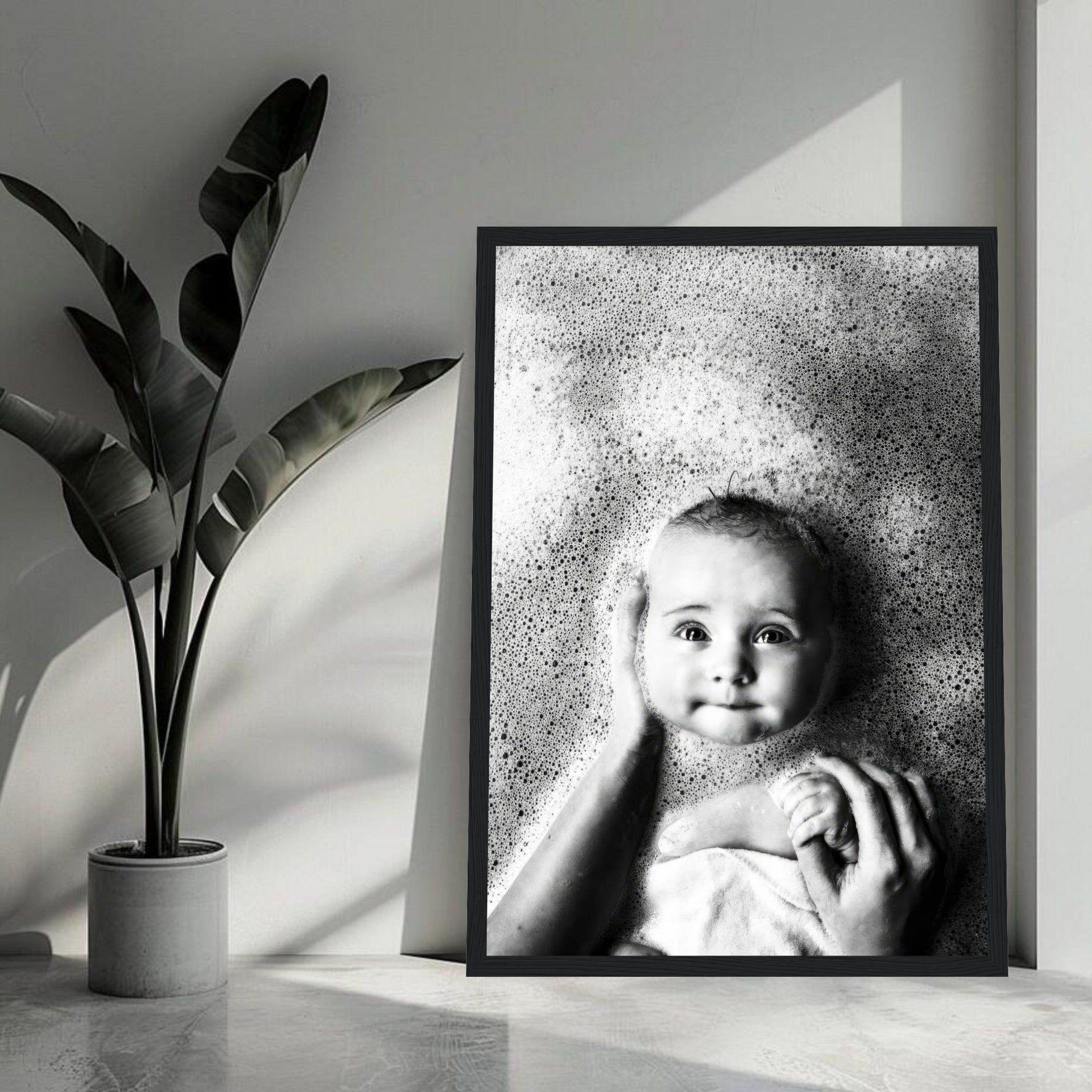 Black-and-white framed print of a baby enjoying bath time, surrounded by bubbles with a joyful expression.