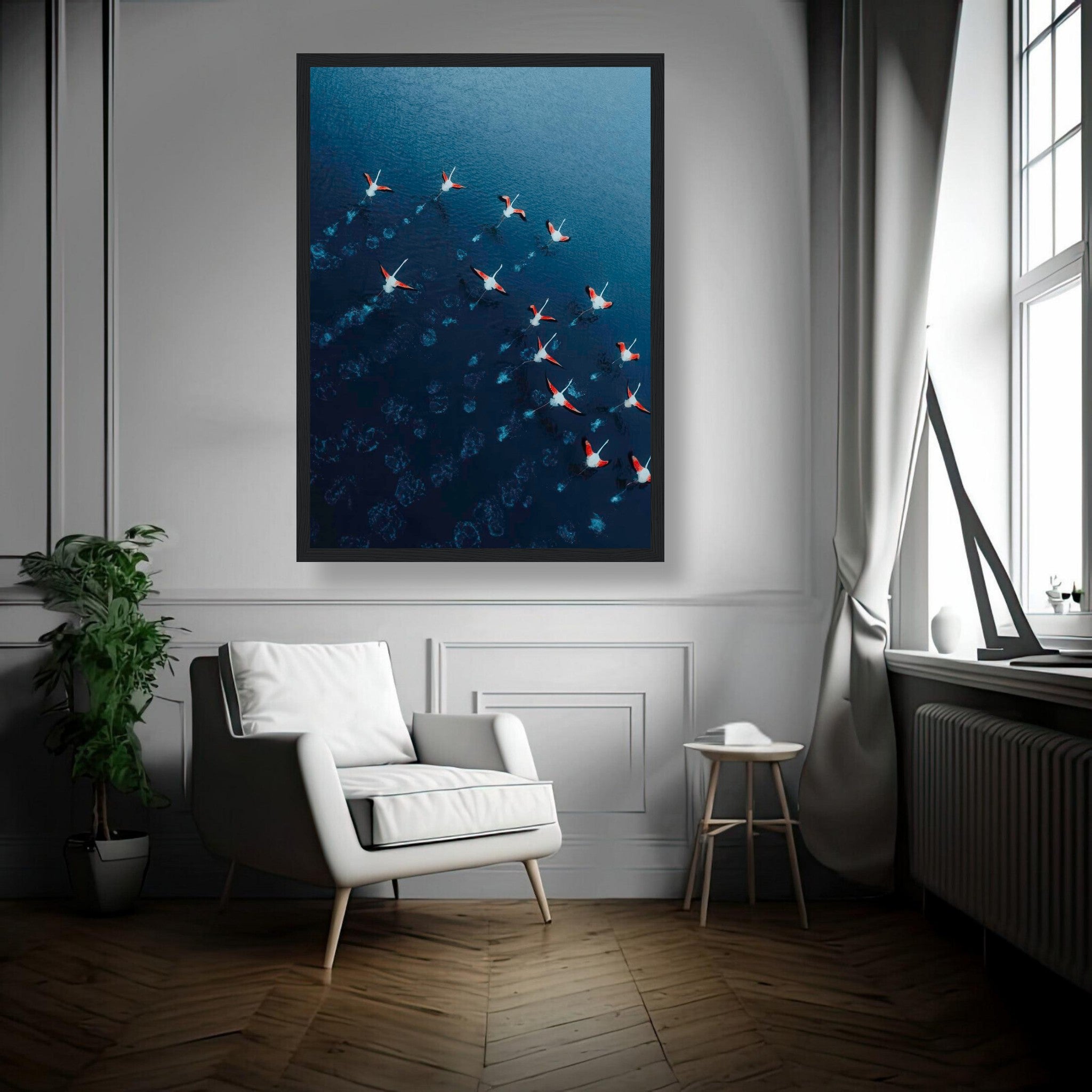 Flamingos drone photography framed print featuring pink flamingos over deep blue waters in a stylish interior.