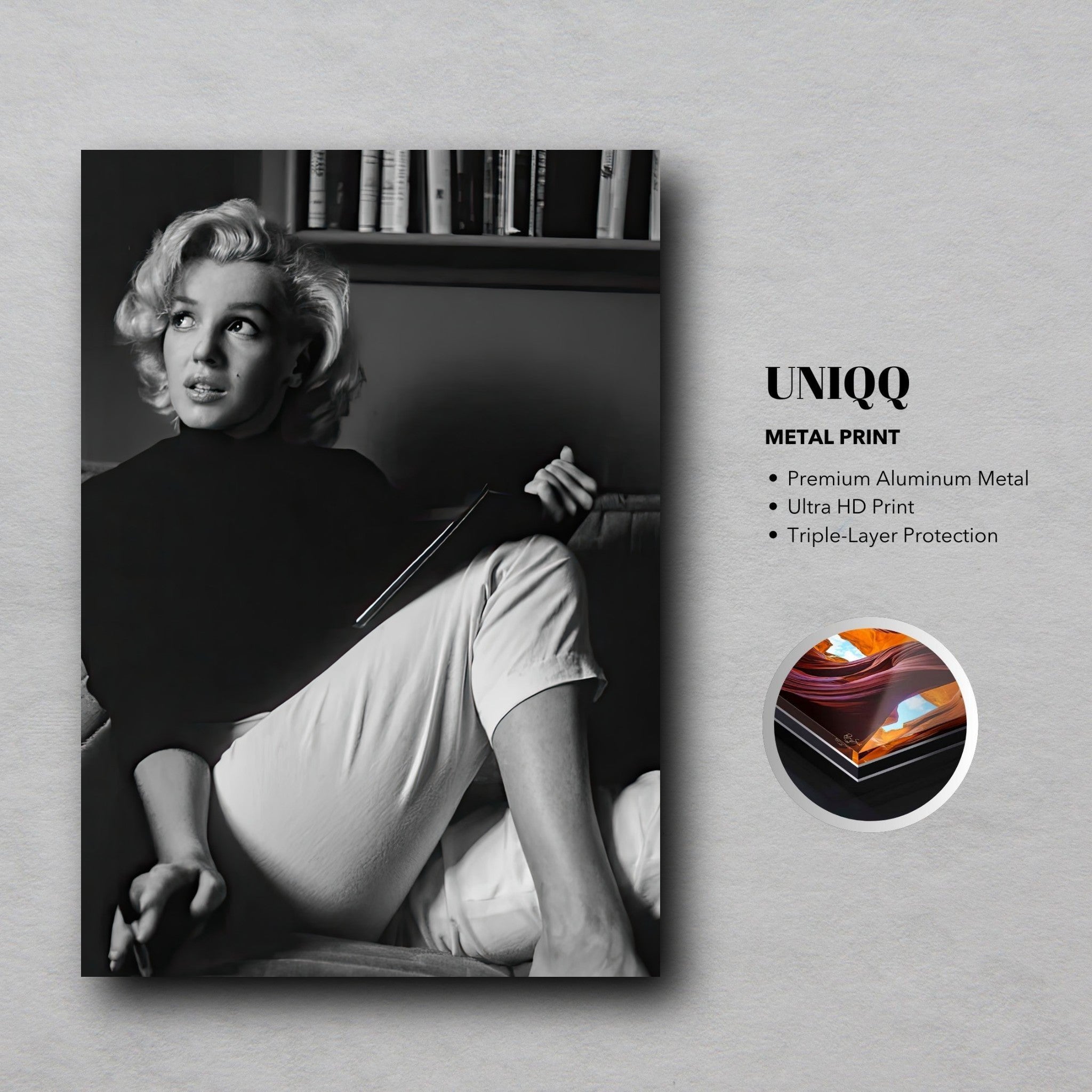 Marilyn Monroe reading a book in black-and-white metal print, showcasing elegance and intellect.