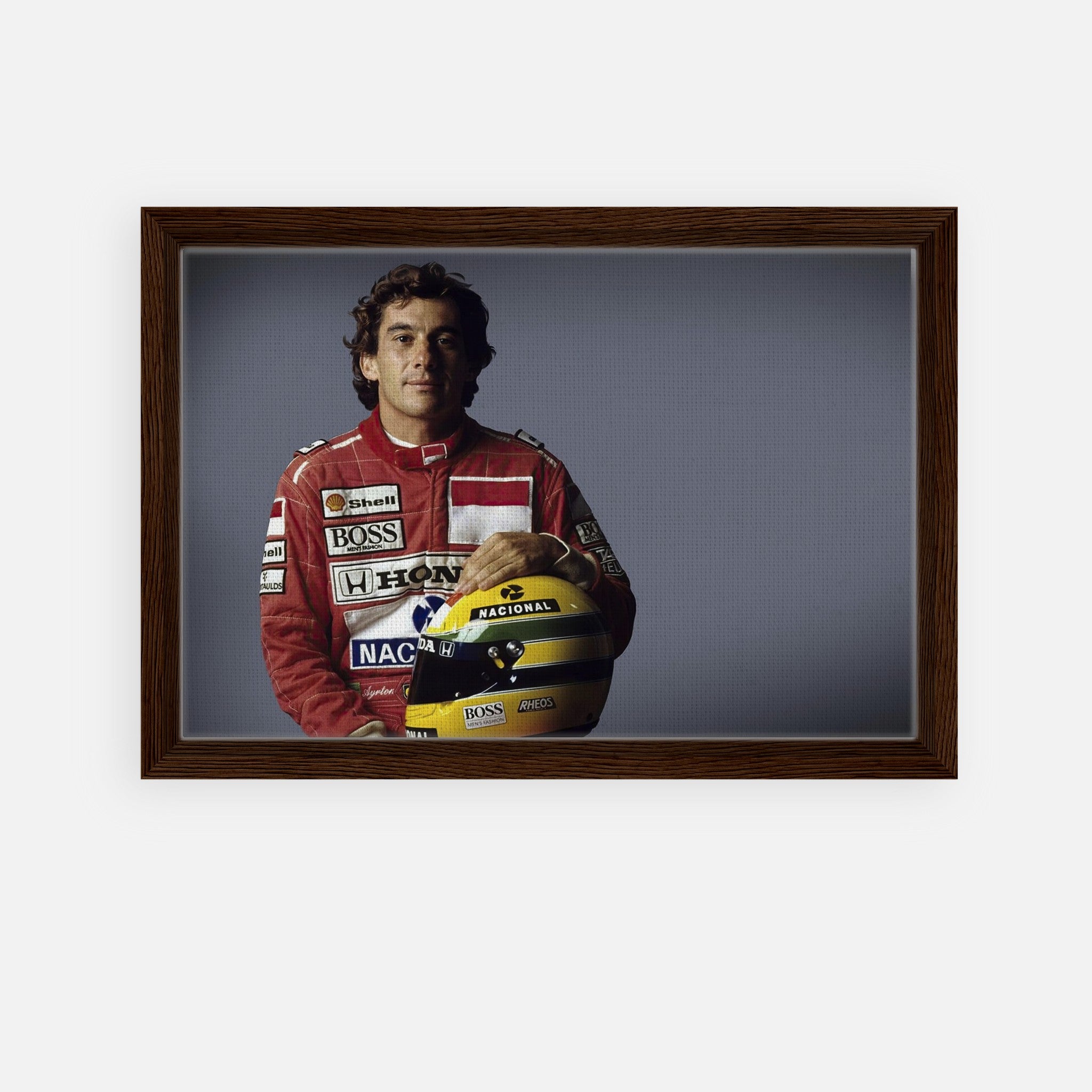 Ayrton Senna in a red racing suit, holding a helmet, framed canvas print for motorsport enthusiasts.