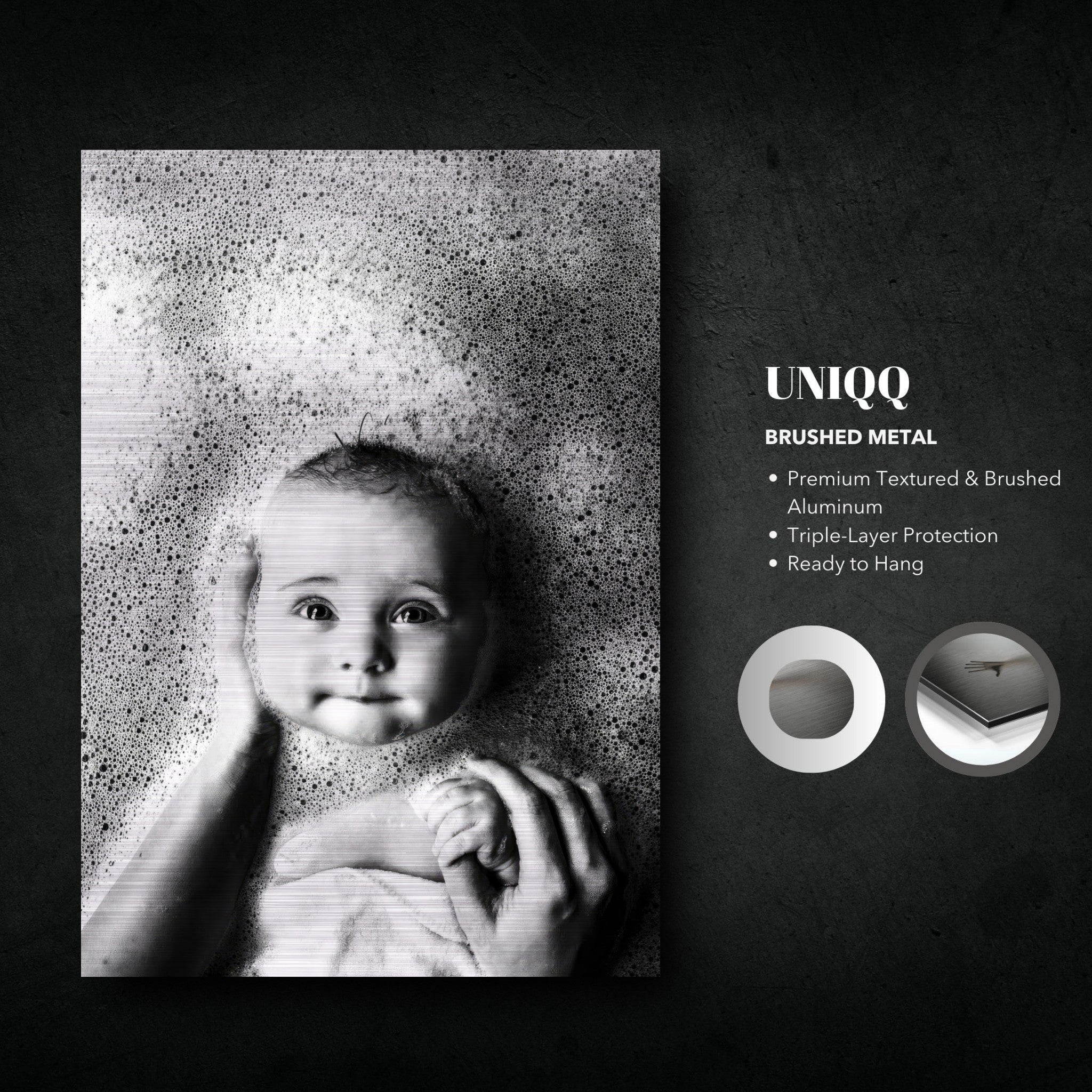 Black and white baby bath photography on brushed metal, capturing innocence and joy during bath time.