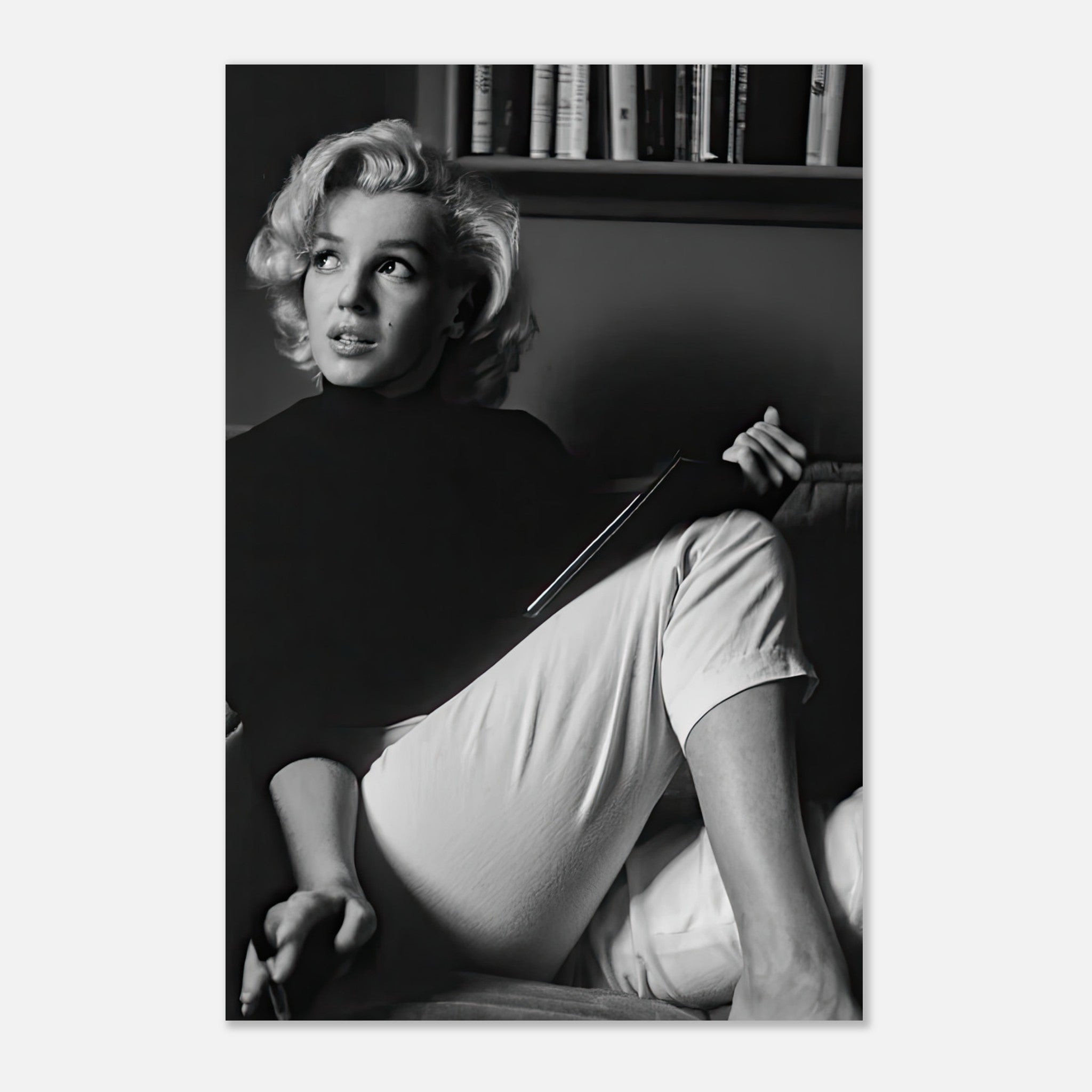 Marilyn Monroe in a black-and-white metal print, reading thoughtfully, showcasing her timeless elegance and beauty.