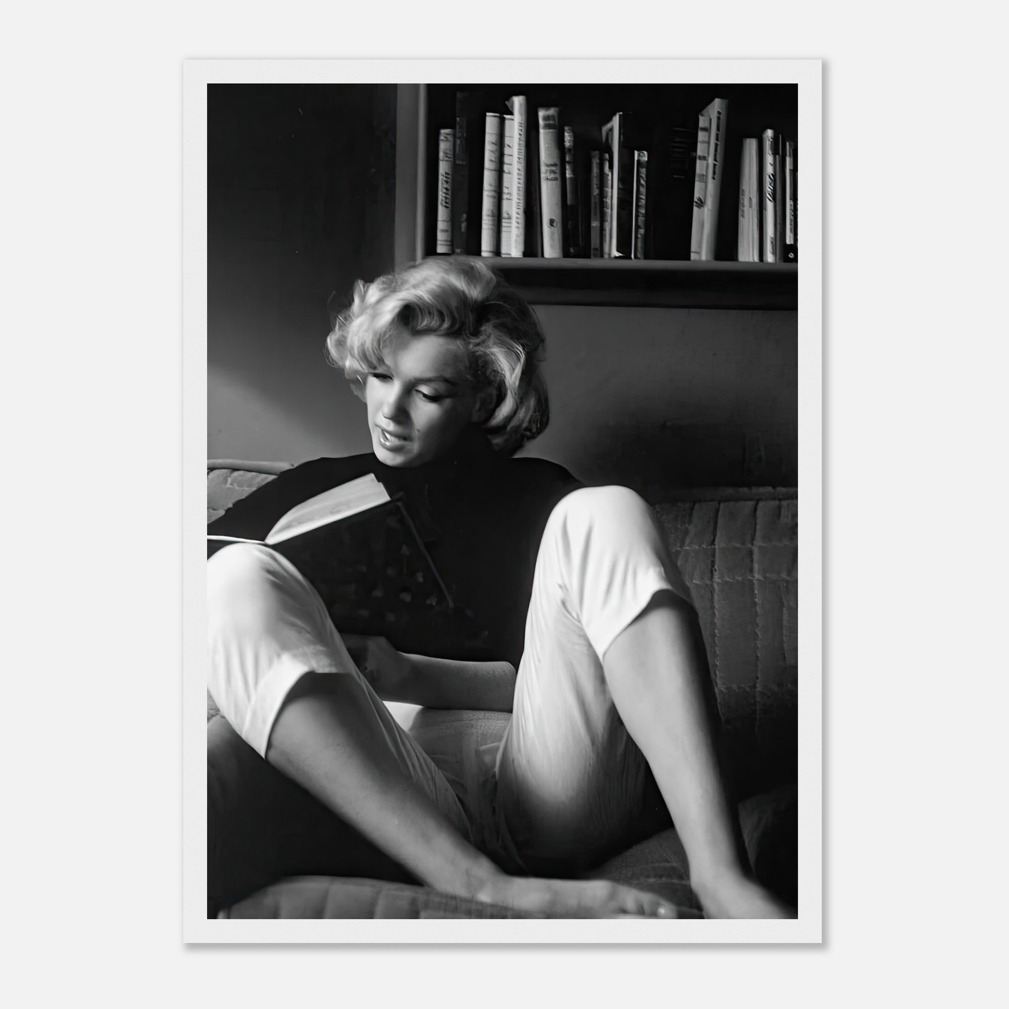 Marilyn Monroe reading at home in a black-and-white framed print, showcasing elegance and classic Hollywood charm.