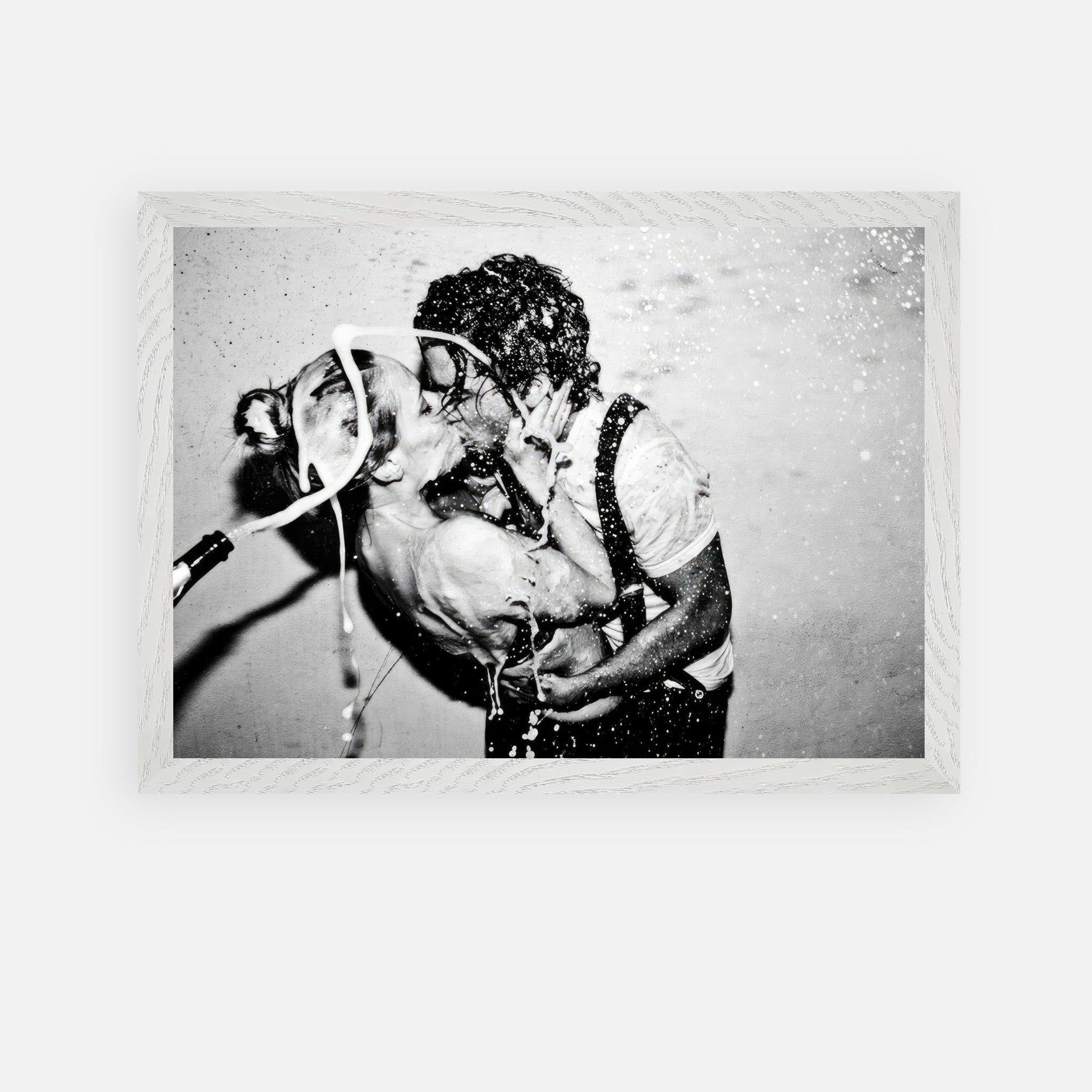 Vintage framed art of Johnny Depp and Kate Moss sharing a passionate kiss with champagne celebration.