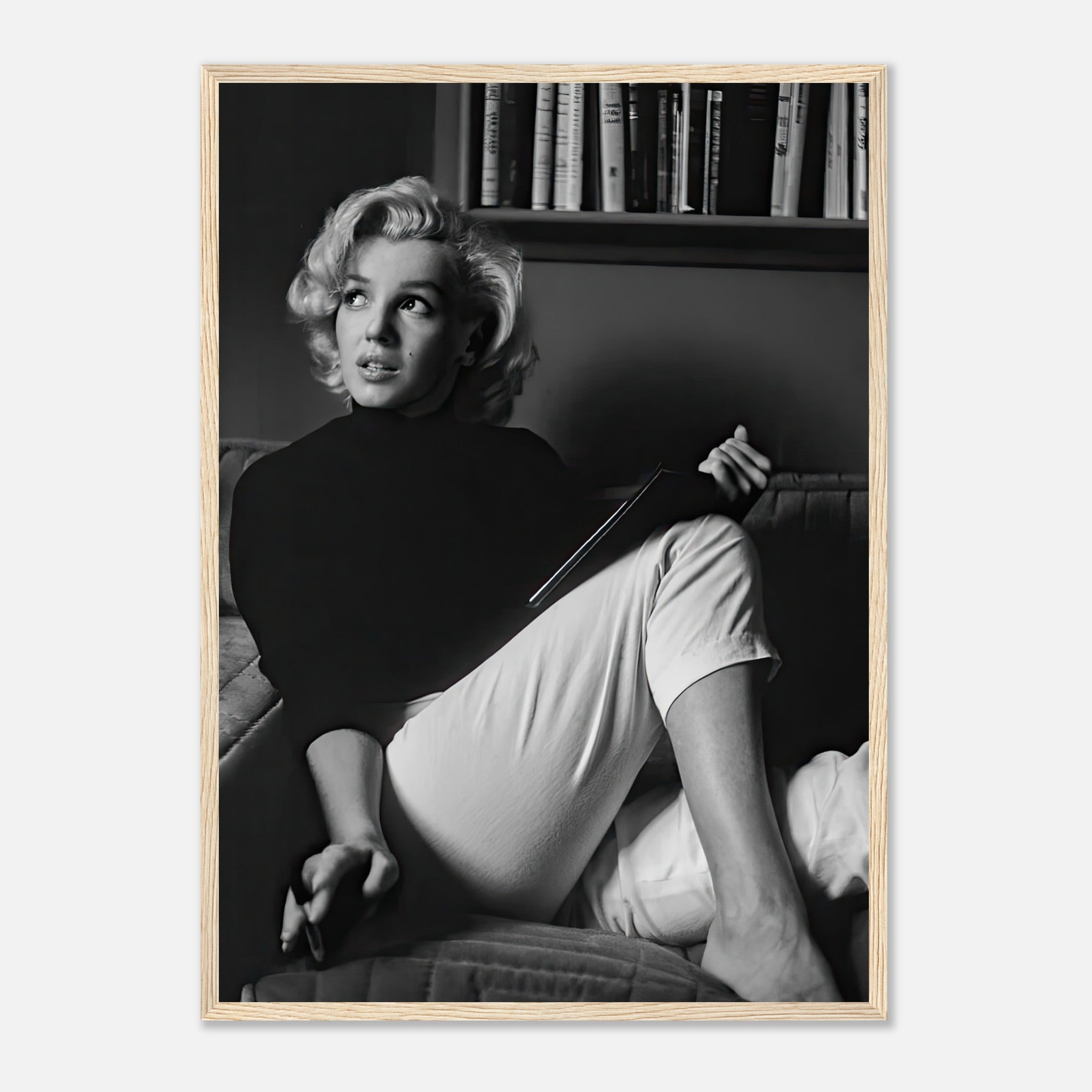 Marilyn Monroe reading a book in black-and-white framed print, adding vintage glamour to any room.