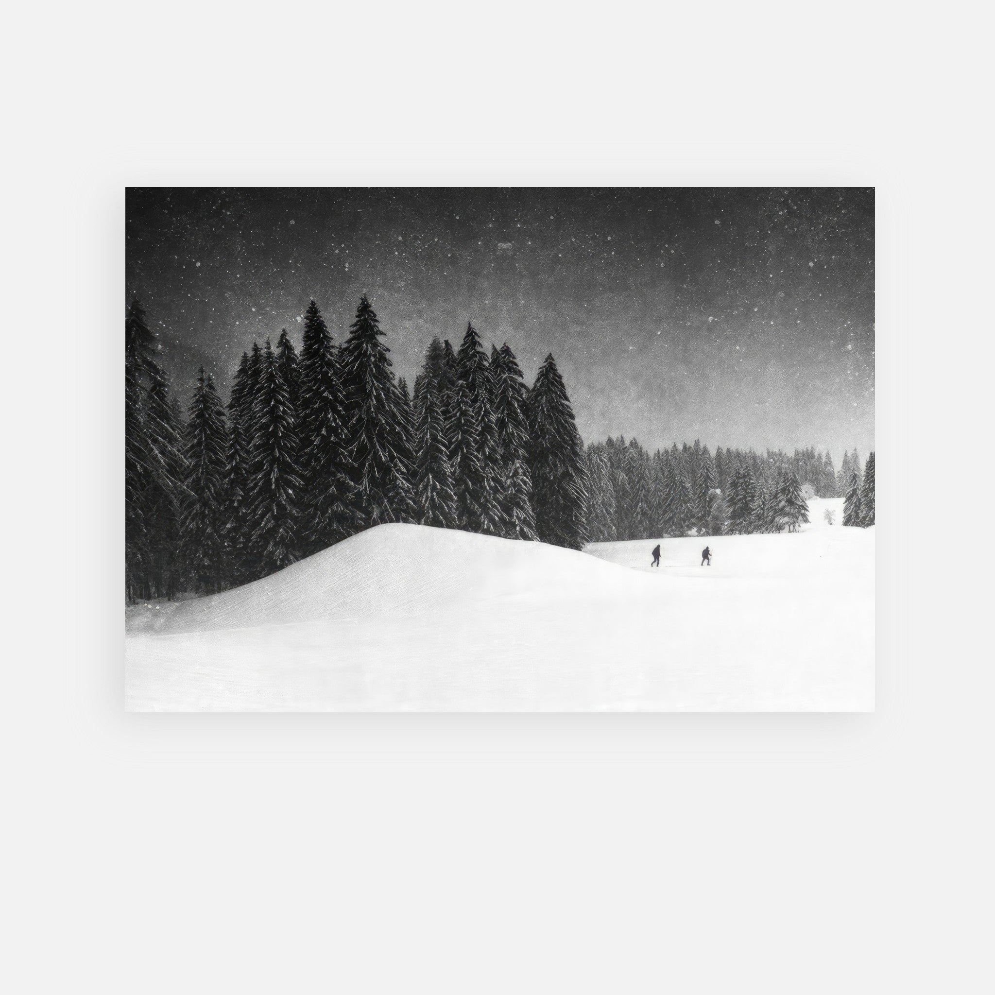 Black-and-white metal print of two figures crossing a snowy field amidst tall evergreens in a serene winter landscape.