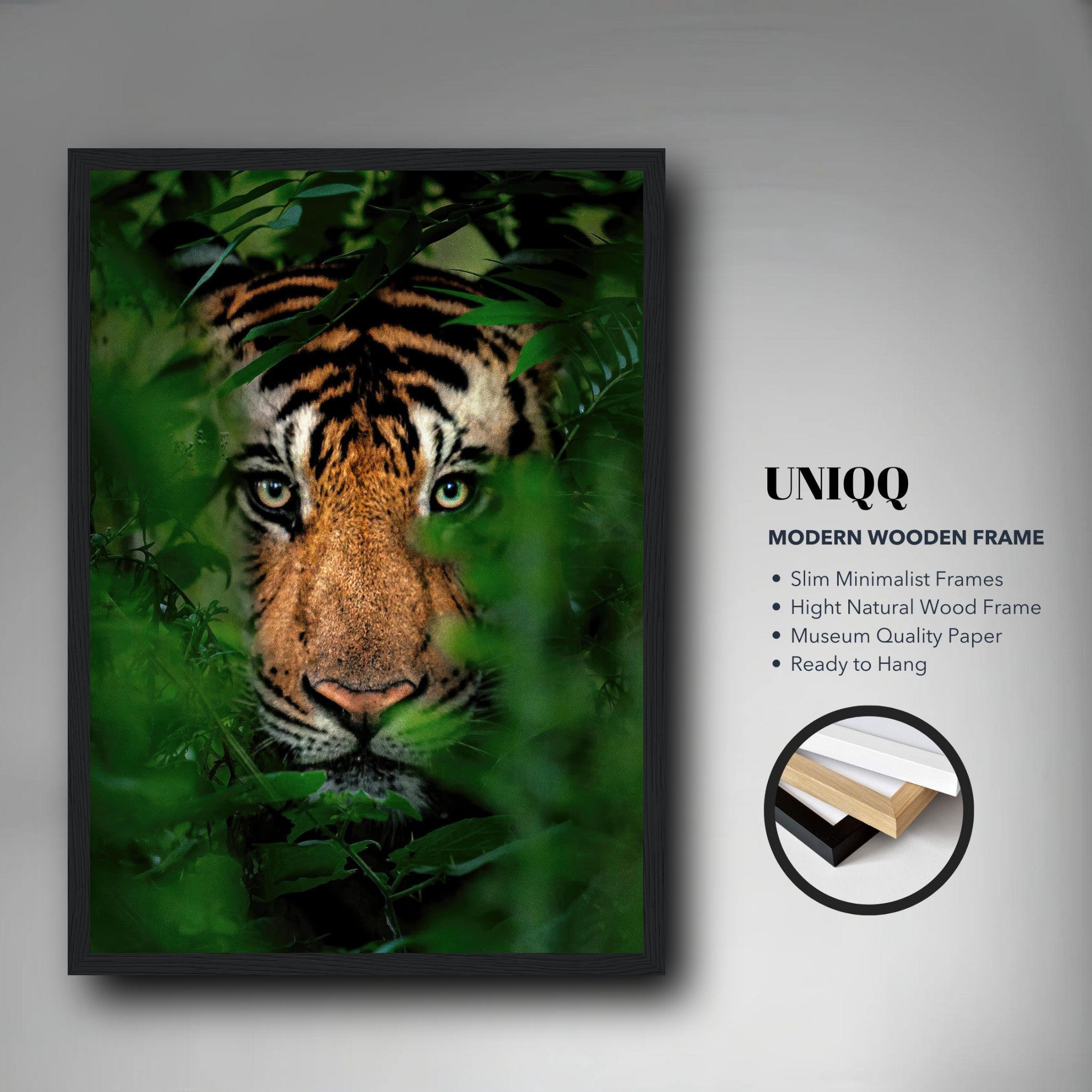 Framed print of a tiger peering through lush jungle foliage, showcasing vibrant colors in a modern wooden frame.