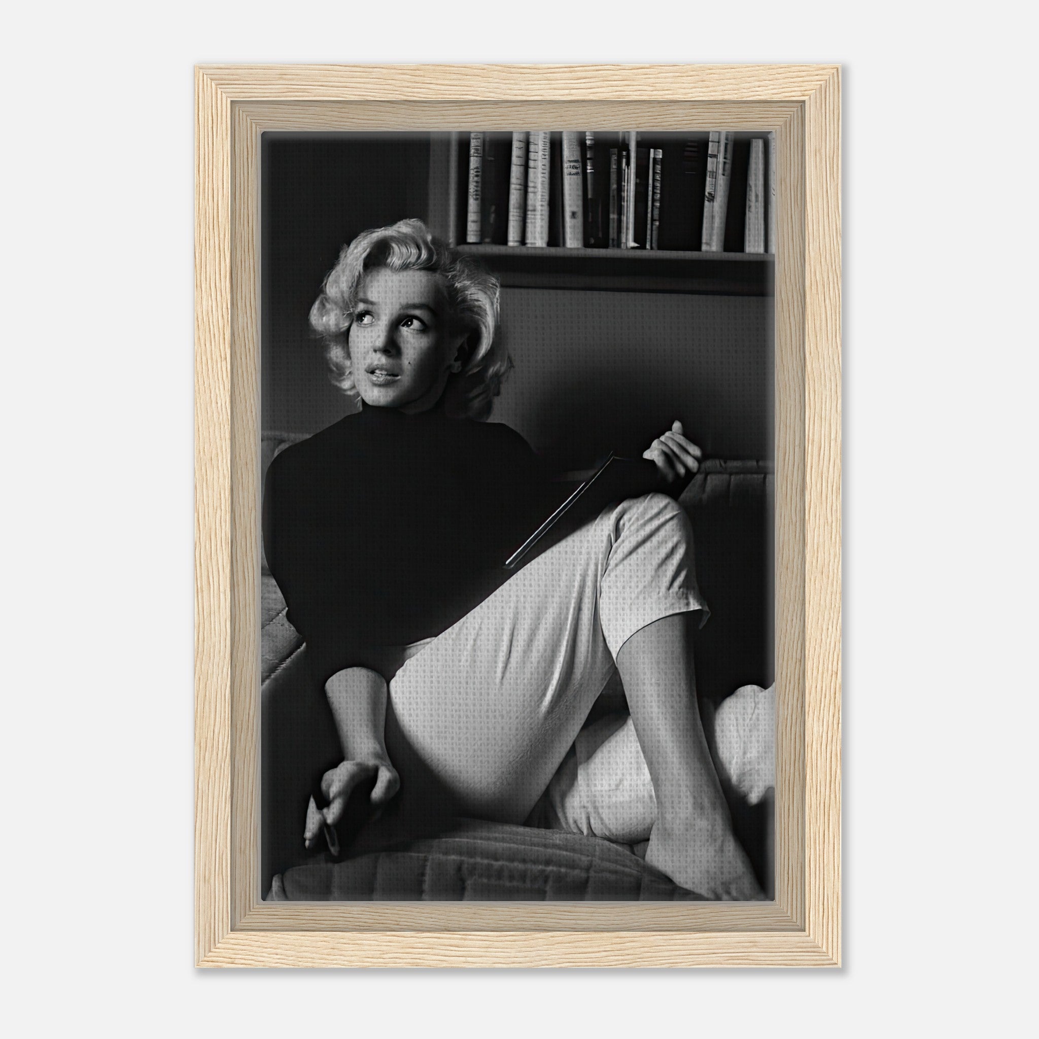Marilyn Monroe framed canvas print reading a book in black and white, showcasing elegance and charm.