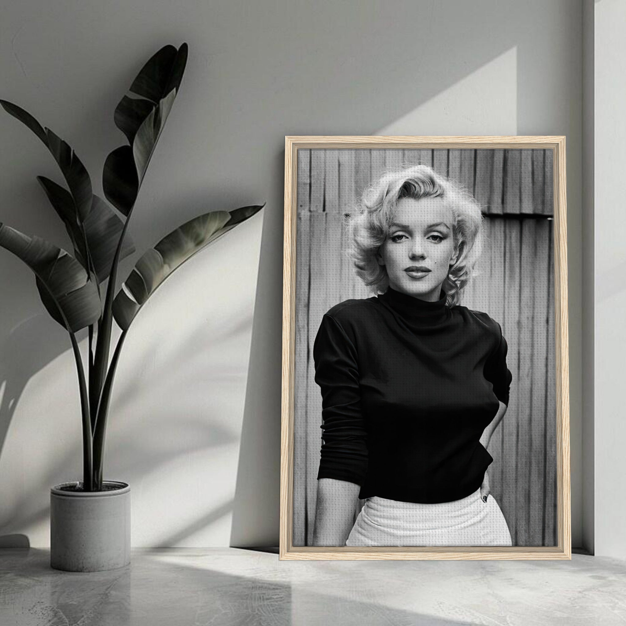 Framed black-and-white portrait of Marilyn Monroe in stylish attire, perfect for home or office decor.