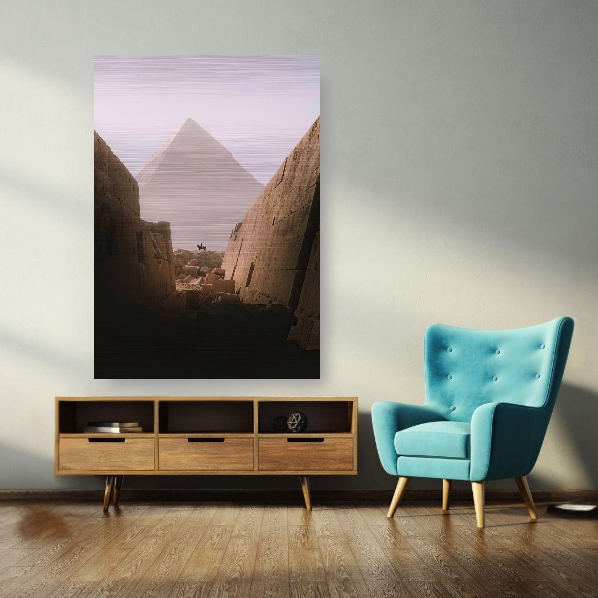 Brushed metal artwork of Great Pyramid of Giza with rider in a modern living room setting.