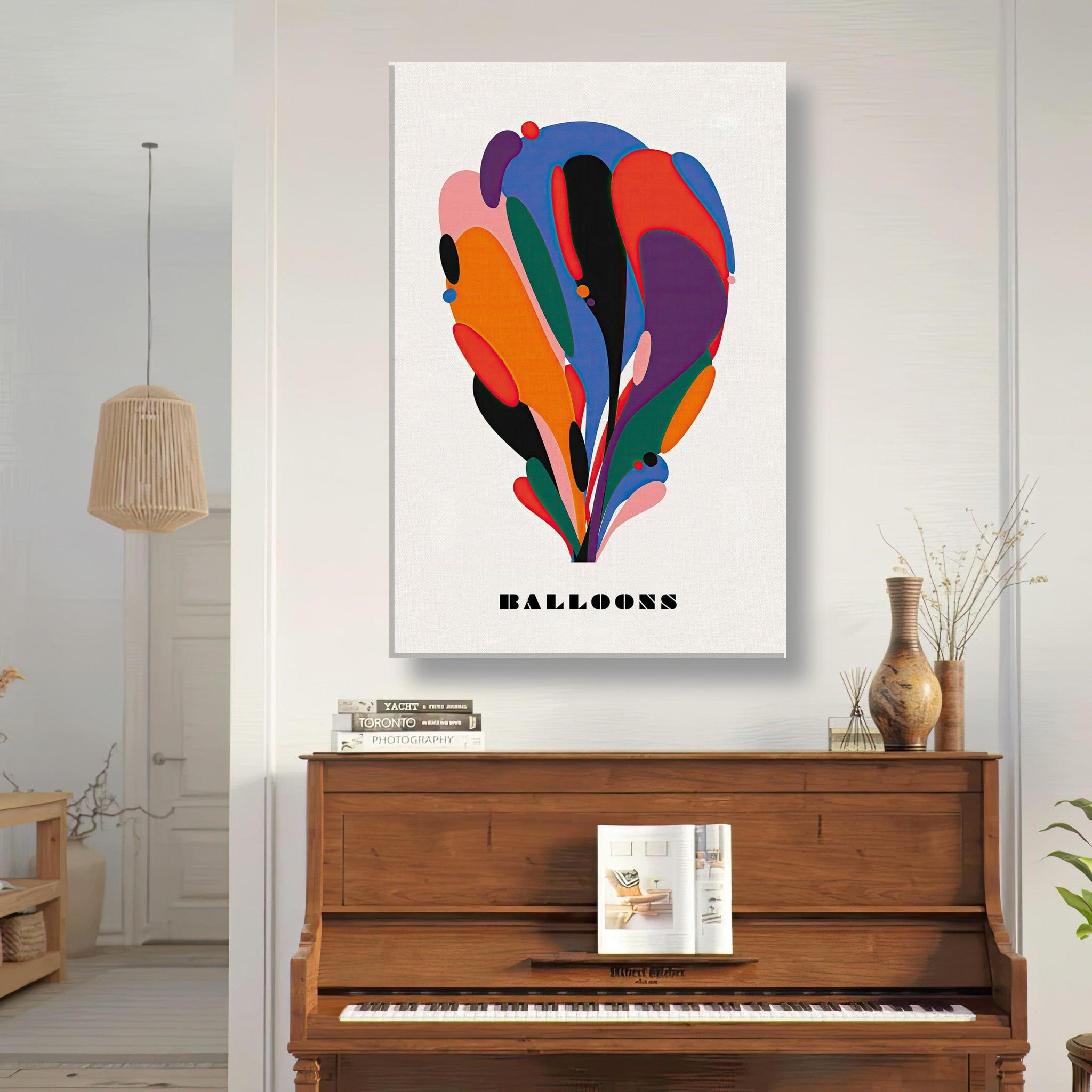 Colorful abstract balloon art canvas print displayed above a piano in a modern interior setting.