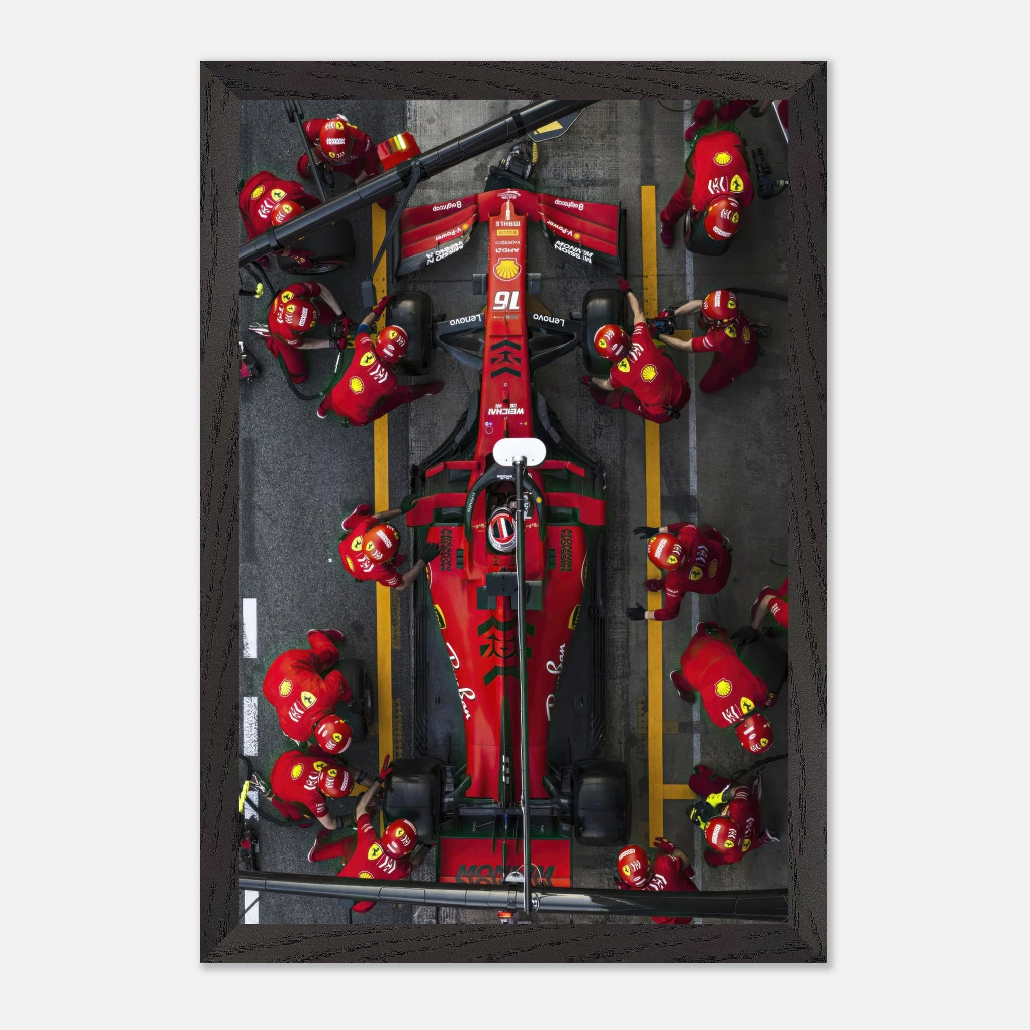 Framed fine art print of a Ferrari Formula 1 pitstop, showcasing teamwork and precision of the pit crew in vibrant detail.