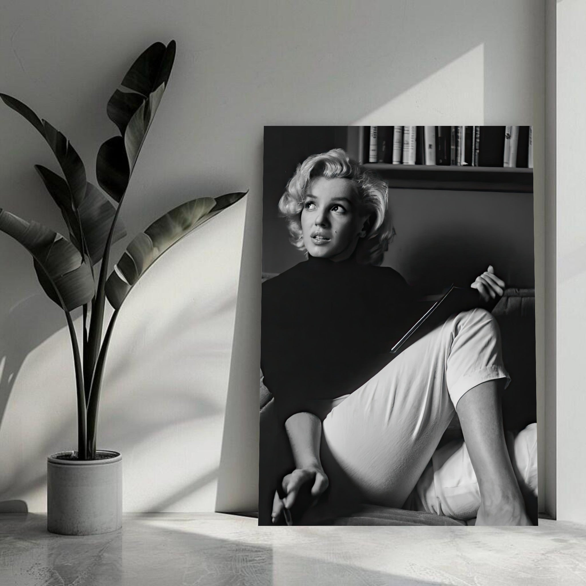 Marilyn Monroe reading a book in black-and-white, showcasing elegance and intellect on a metal print.