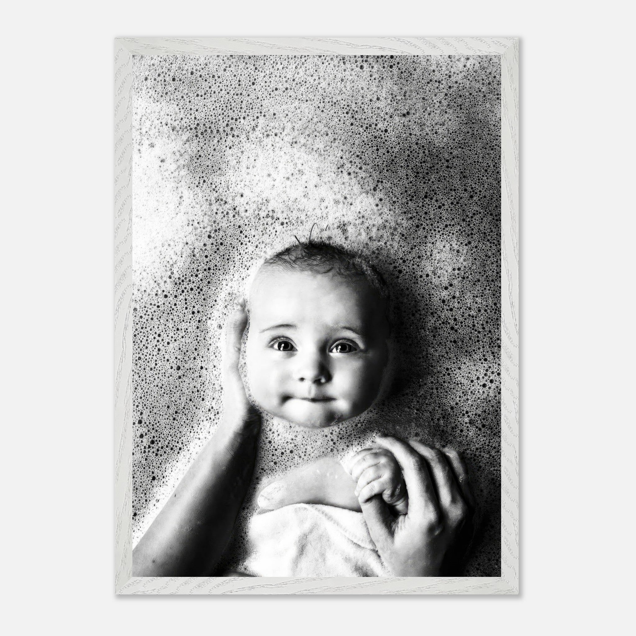 Black-and-white fine art baby bath photography capturing joy and innocence in soft bubbles.