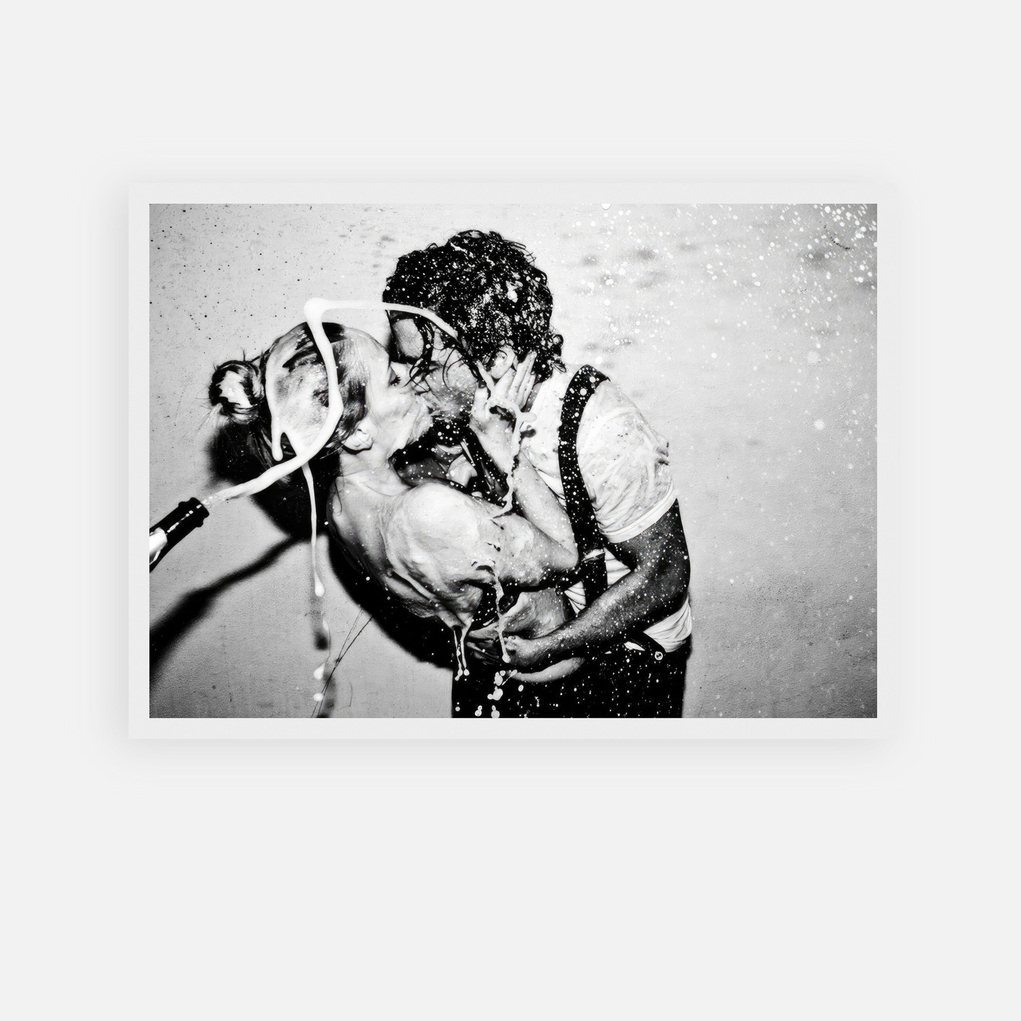 Black-and-white framed print of a passionate kiss between Johnny Depp and Kate Moss with champagne explosion.