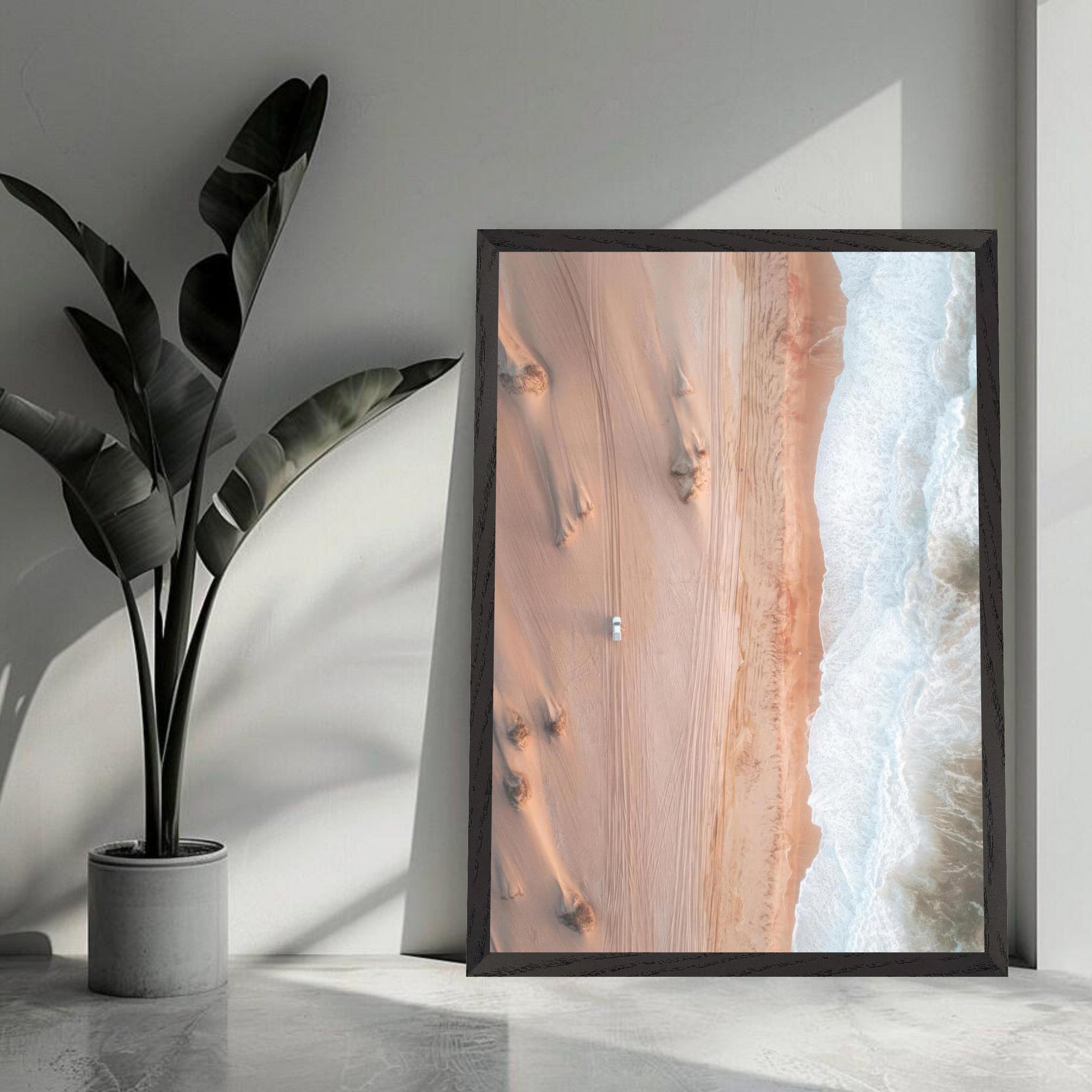 Drone photograph of desert meeting ocean in a framed art piece, showcasing nature's stunning contrast.