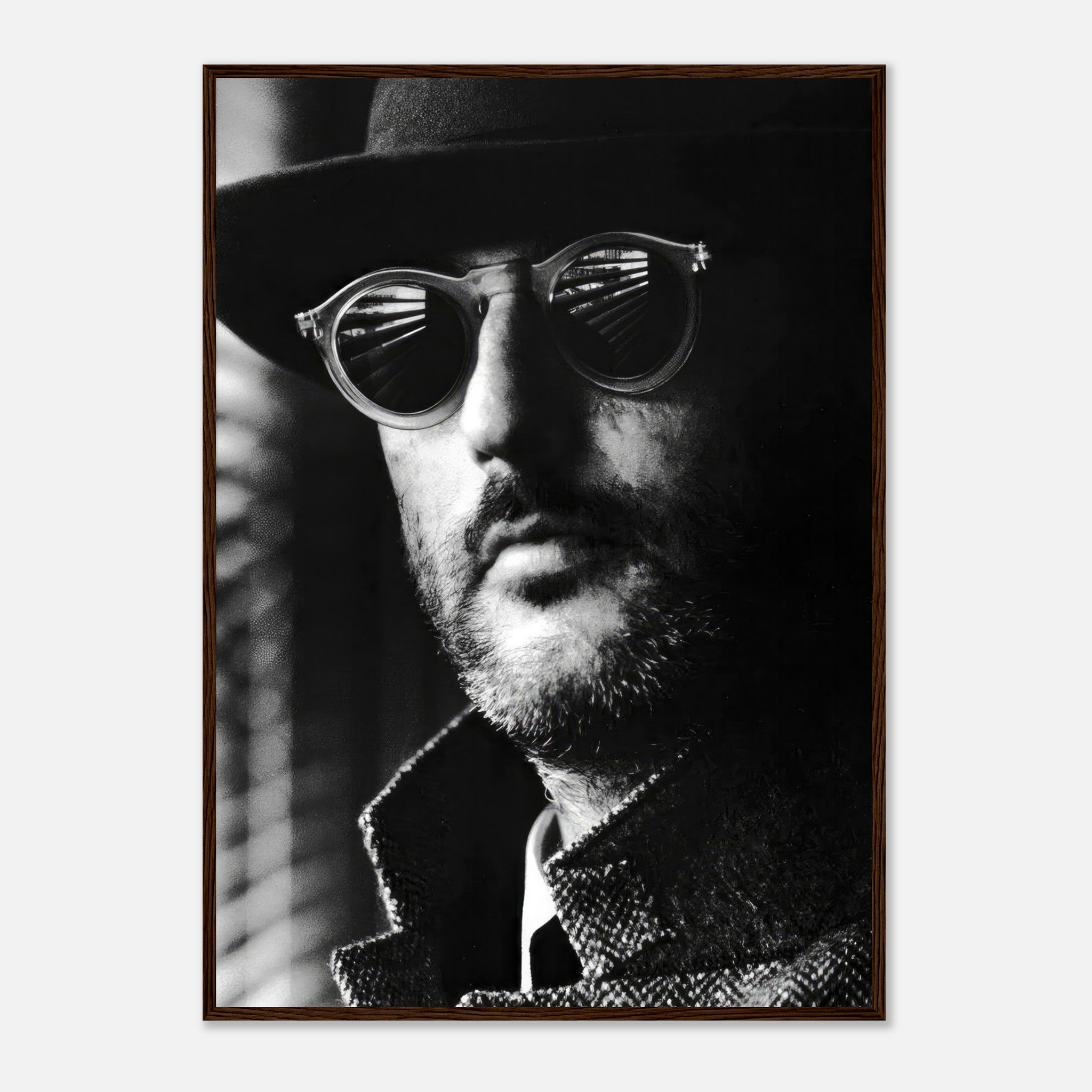 Jean Reno in iconic black-and-white photography, wearing stylish sunglasses and a hat, framed artwork for sophisticated decor.