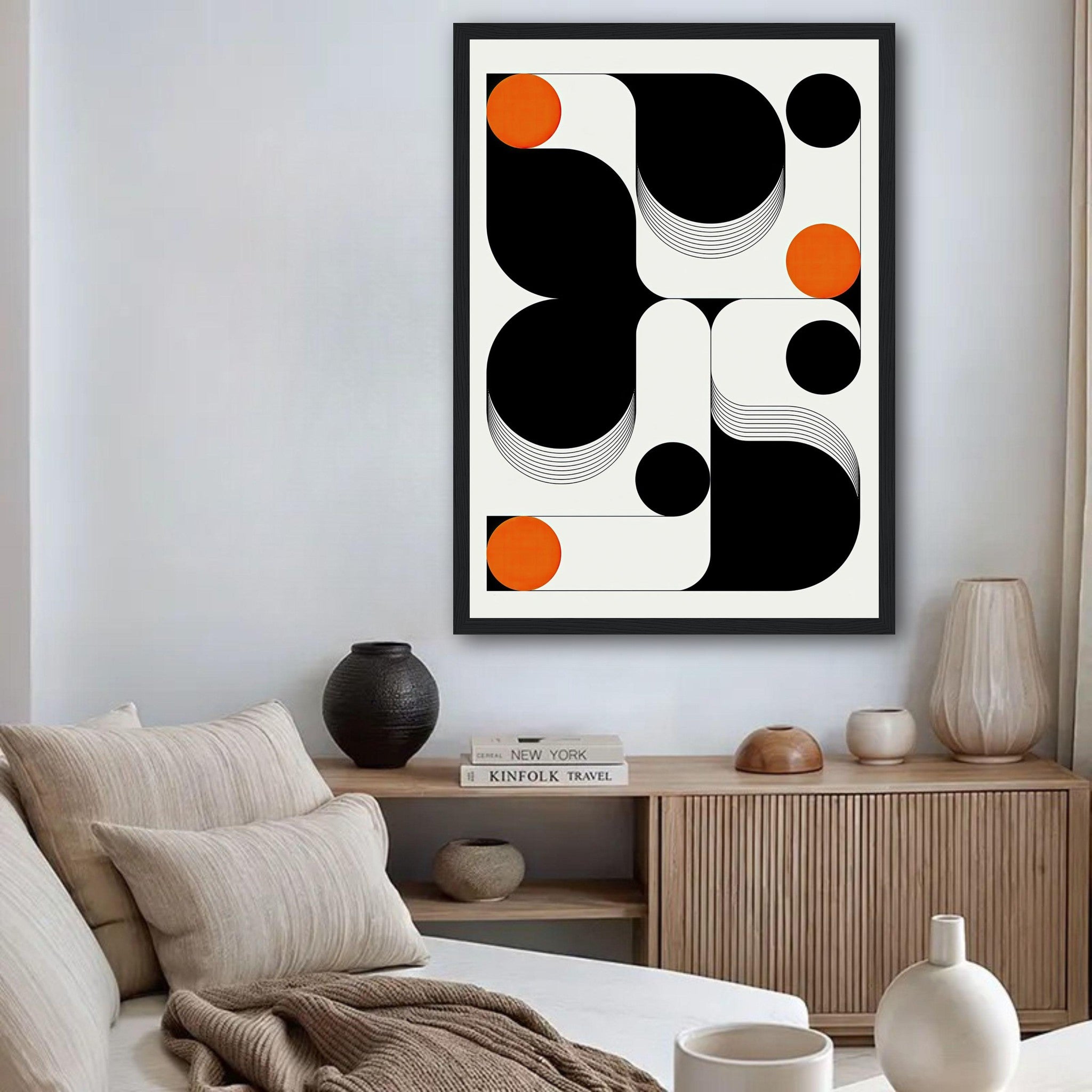 Framed modern geometric abstract art print in black, white, and orange, enhancing a contemporary living space.