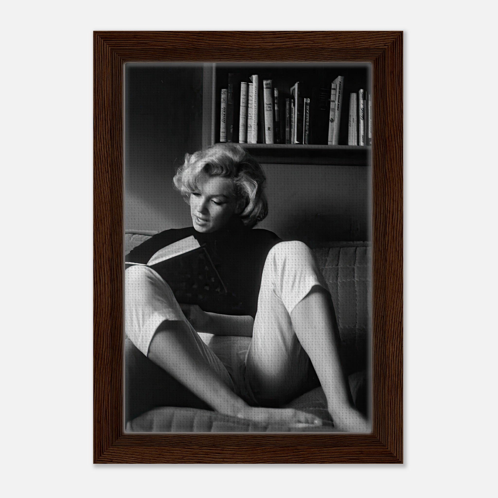 Marilyn Monroe reading in a serene moment, framed canvas artwork showcasing elegance and sophistication.