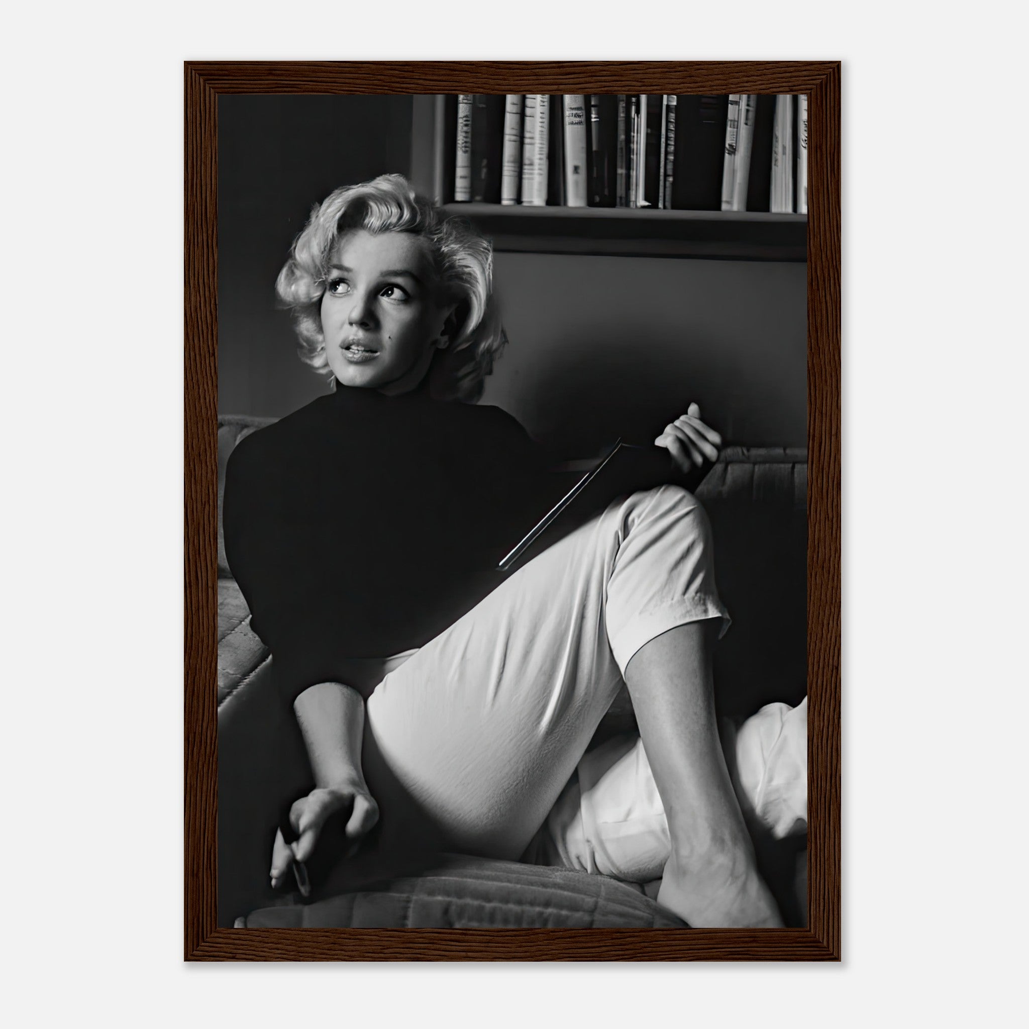 Marilyn Monroe reading a book in a serene black-and-white framed print, adding vintage glamour to any space.