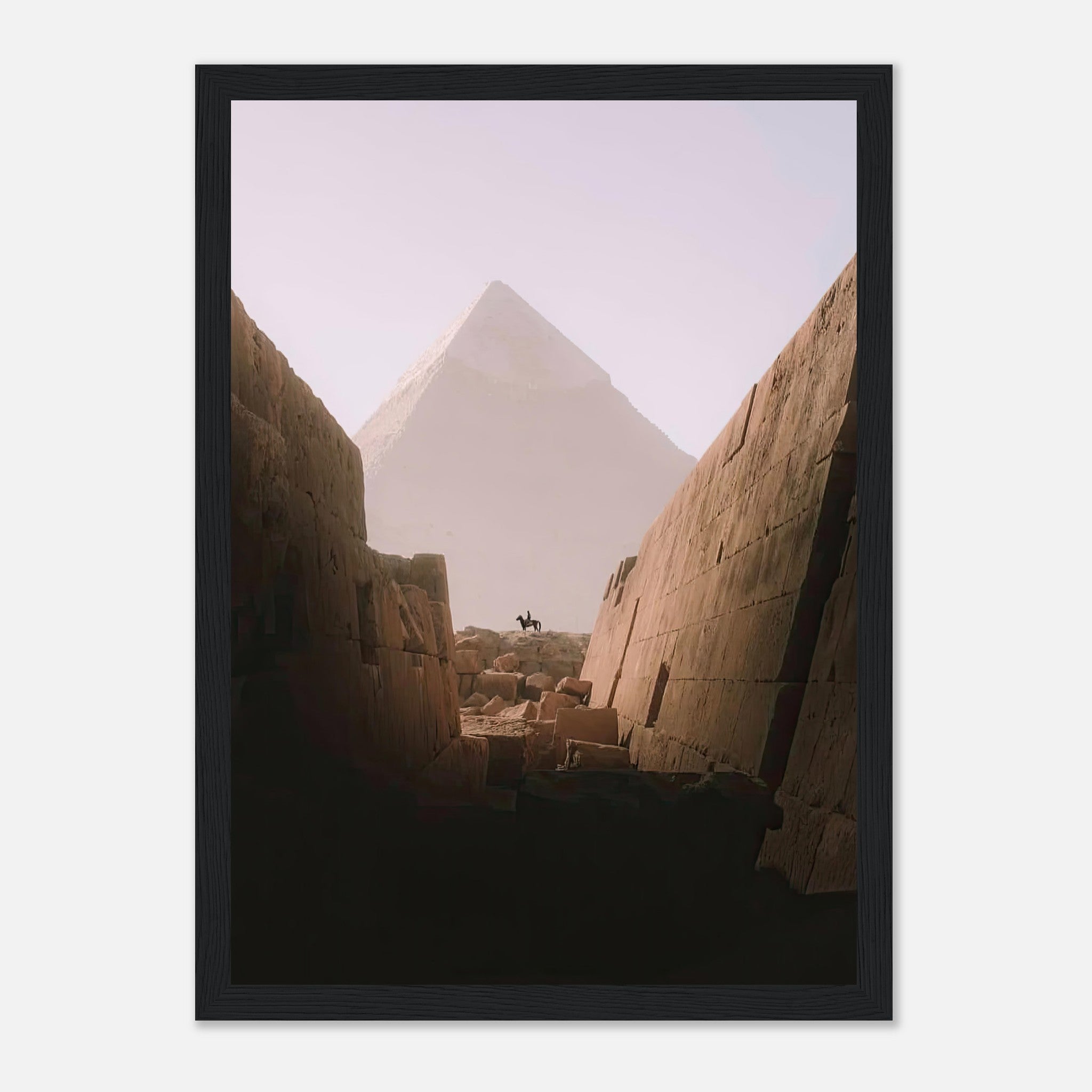 Framed print of a lone rider silhouetted against the Great Pyramid of Giza, captured from within ancient stone walls.